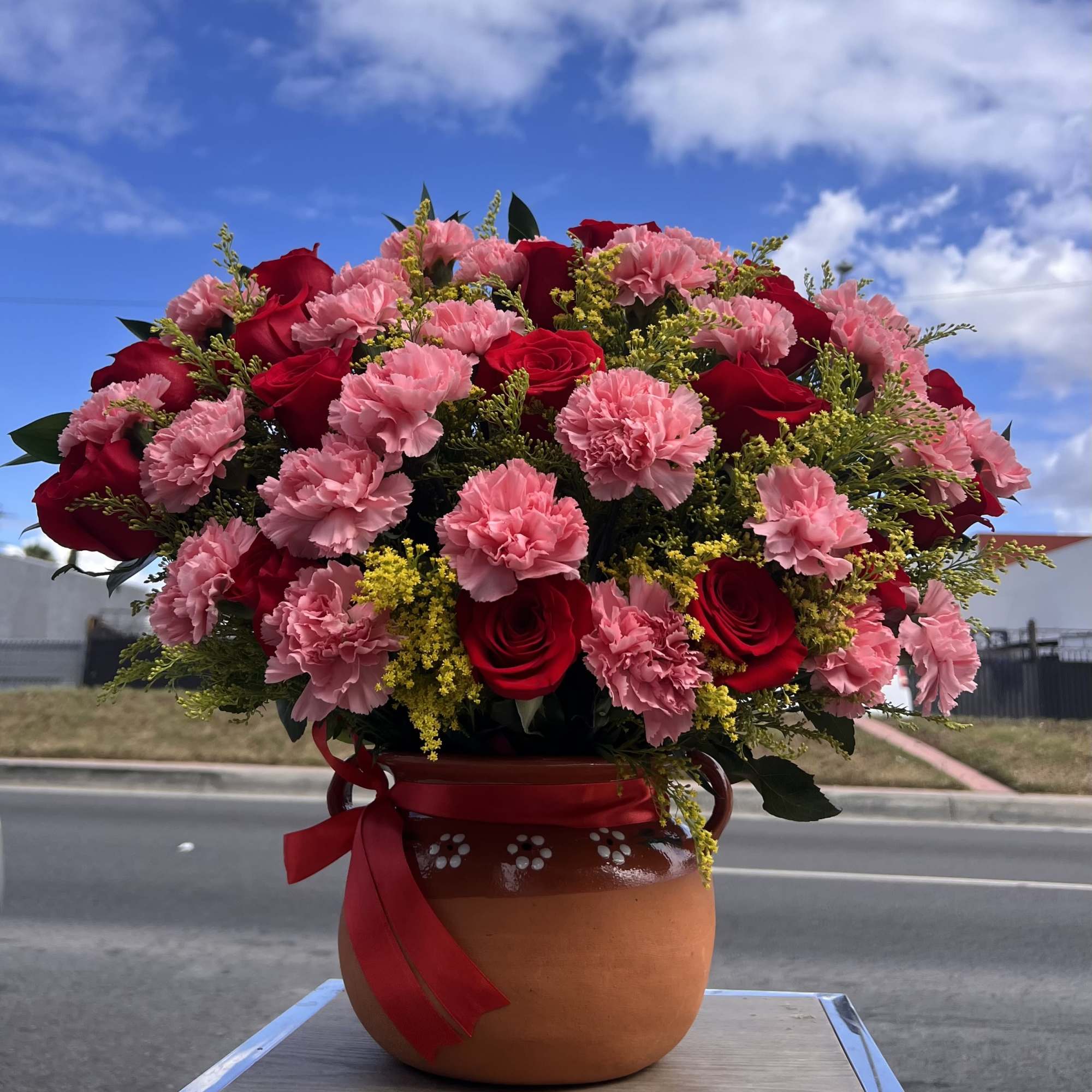 A stunning blend of red roses and soft pink blooms, perfect for