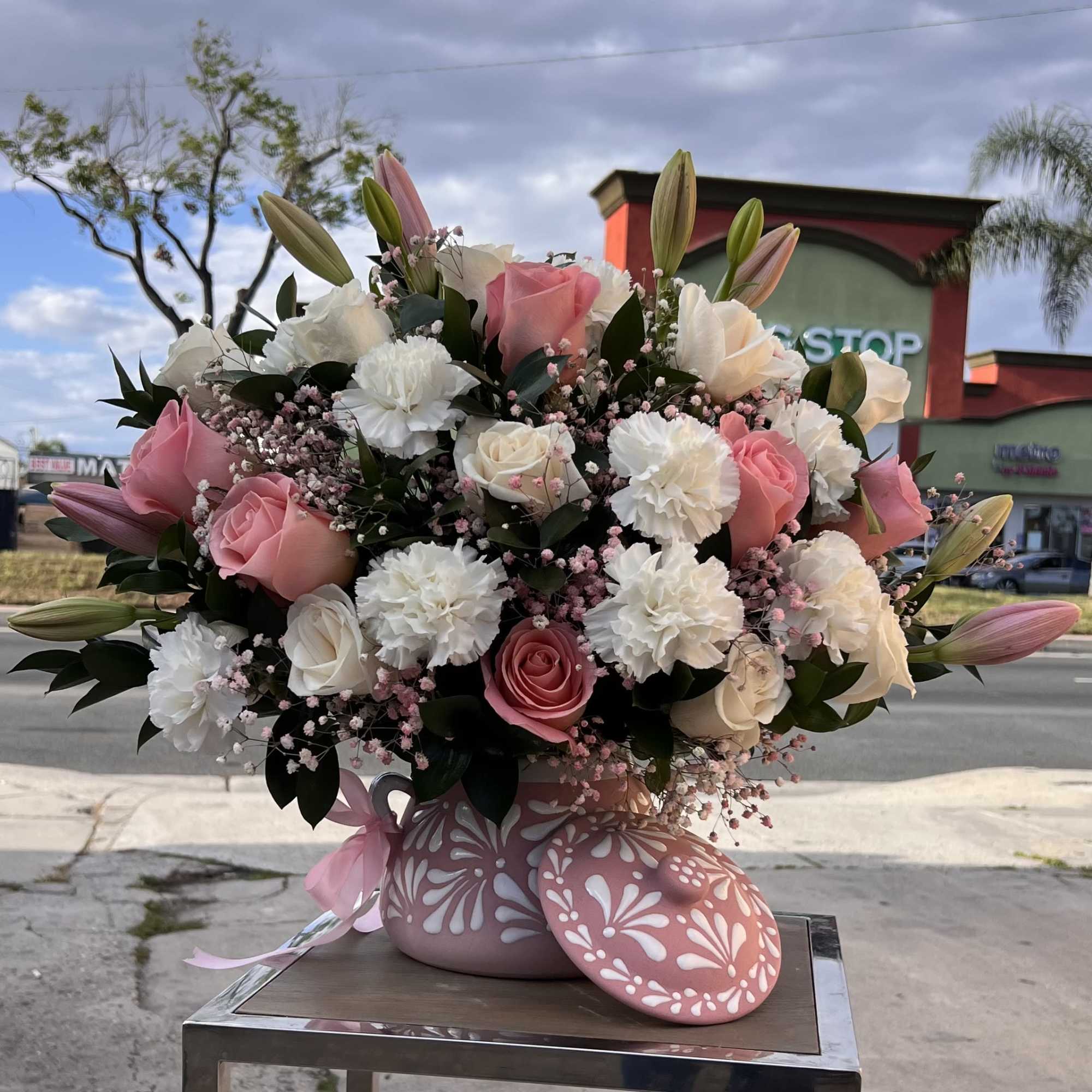 A stunning blend of Pink roses and soft white blooms, perfect for