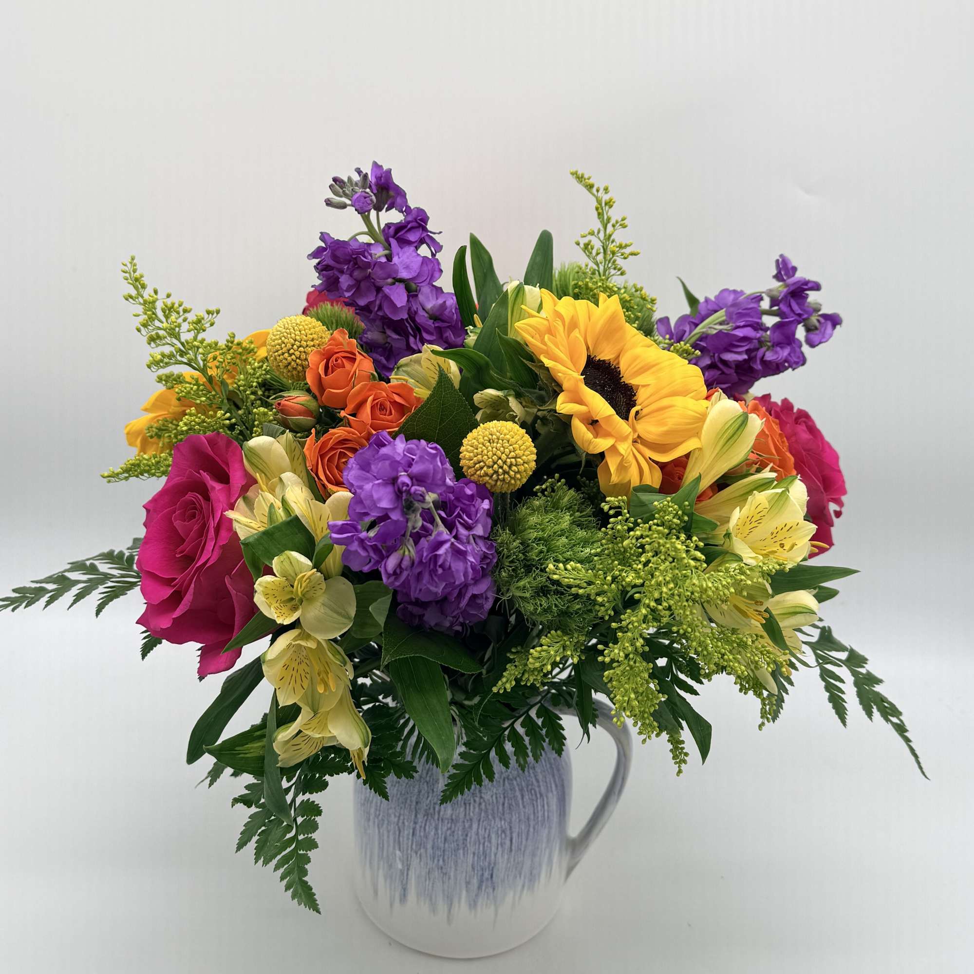 Bright, cheerful, and full of charm, this vibrant arrangement is beautifully designed