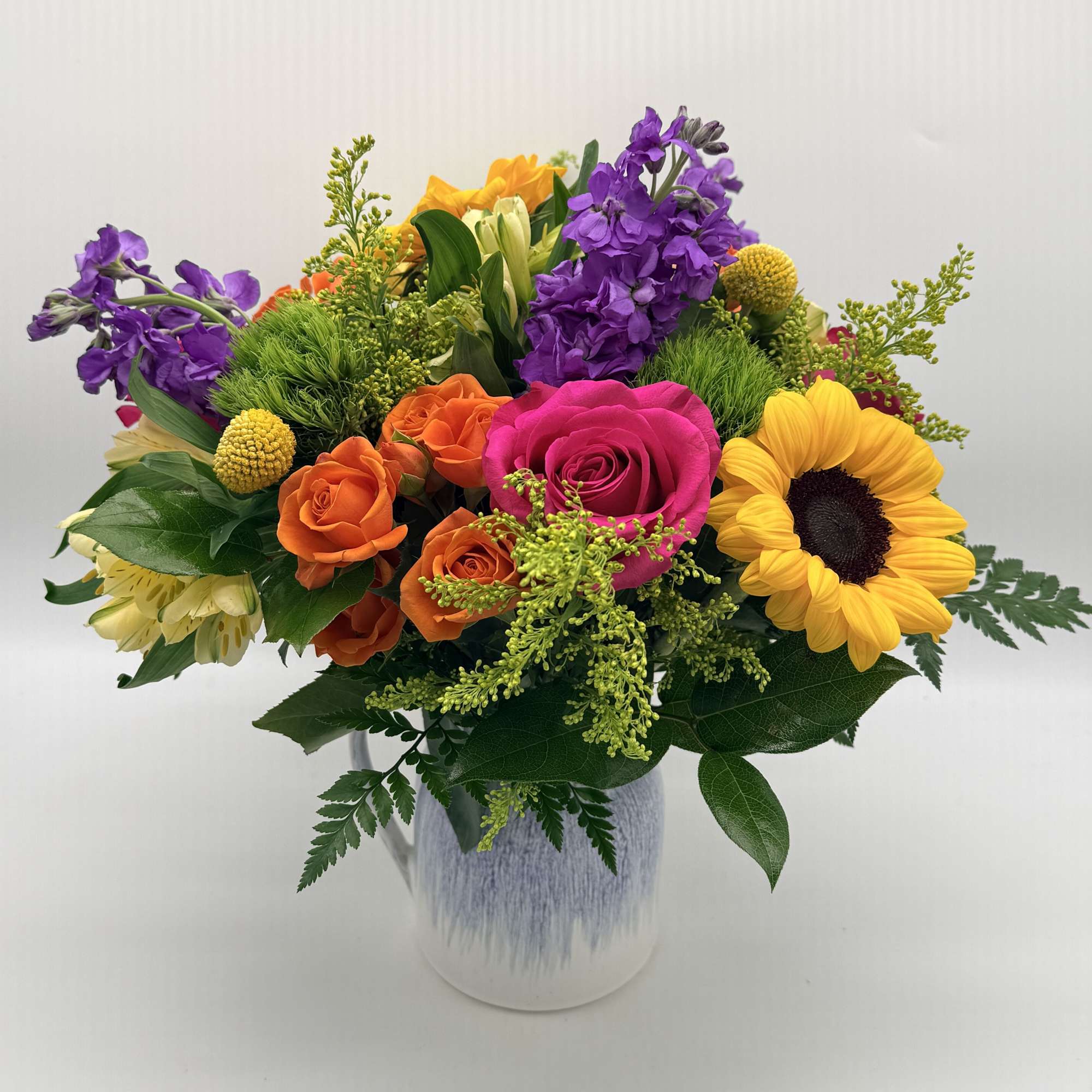 Bright, cheerful, and full of charm, this vibrant arrangement is beautifully designed