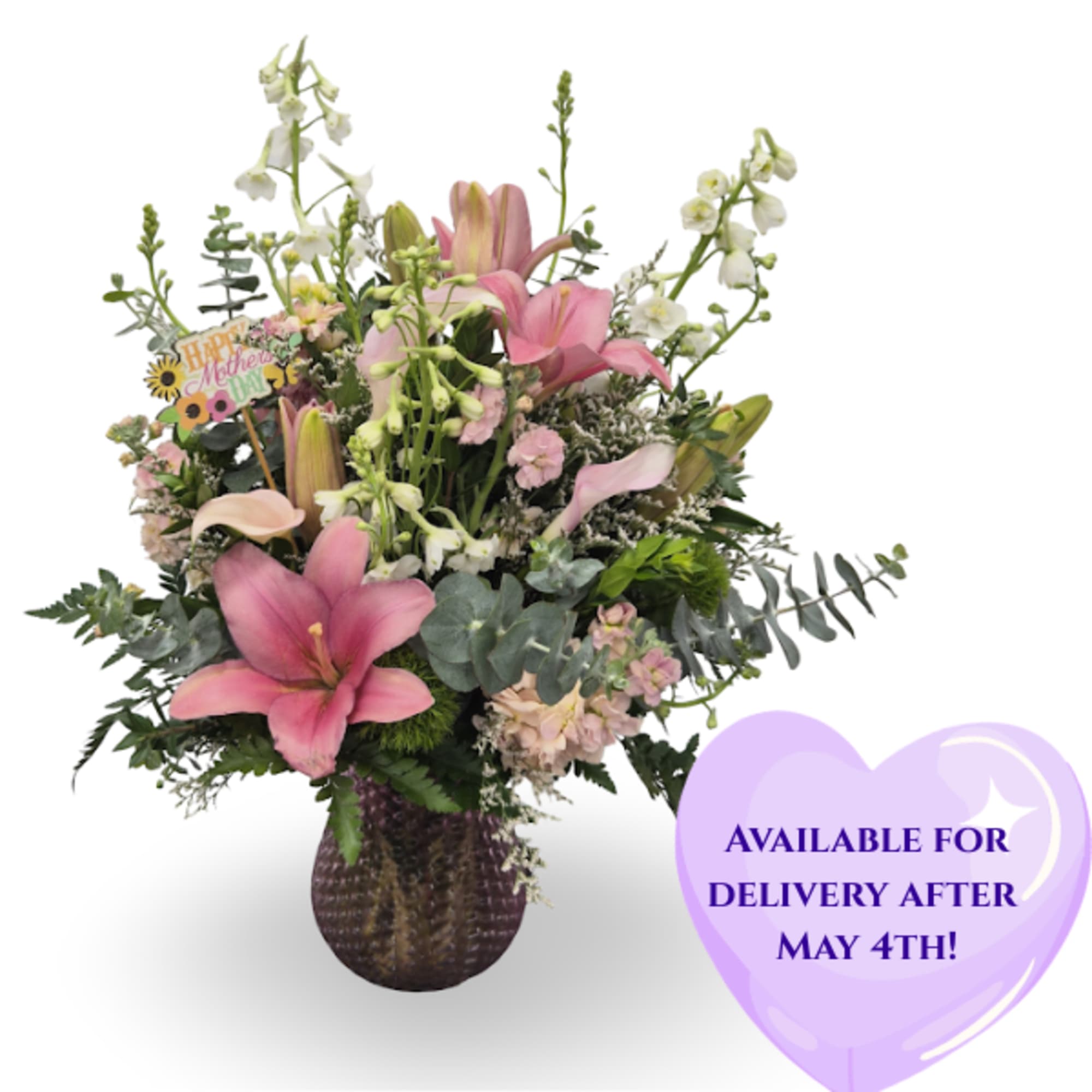 Soft pink lilies take center stage in this garden-style flower arrangement, a