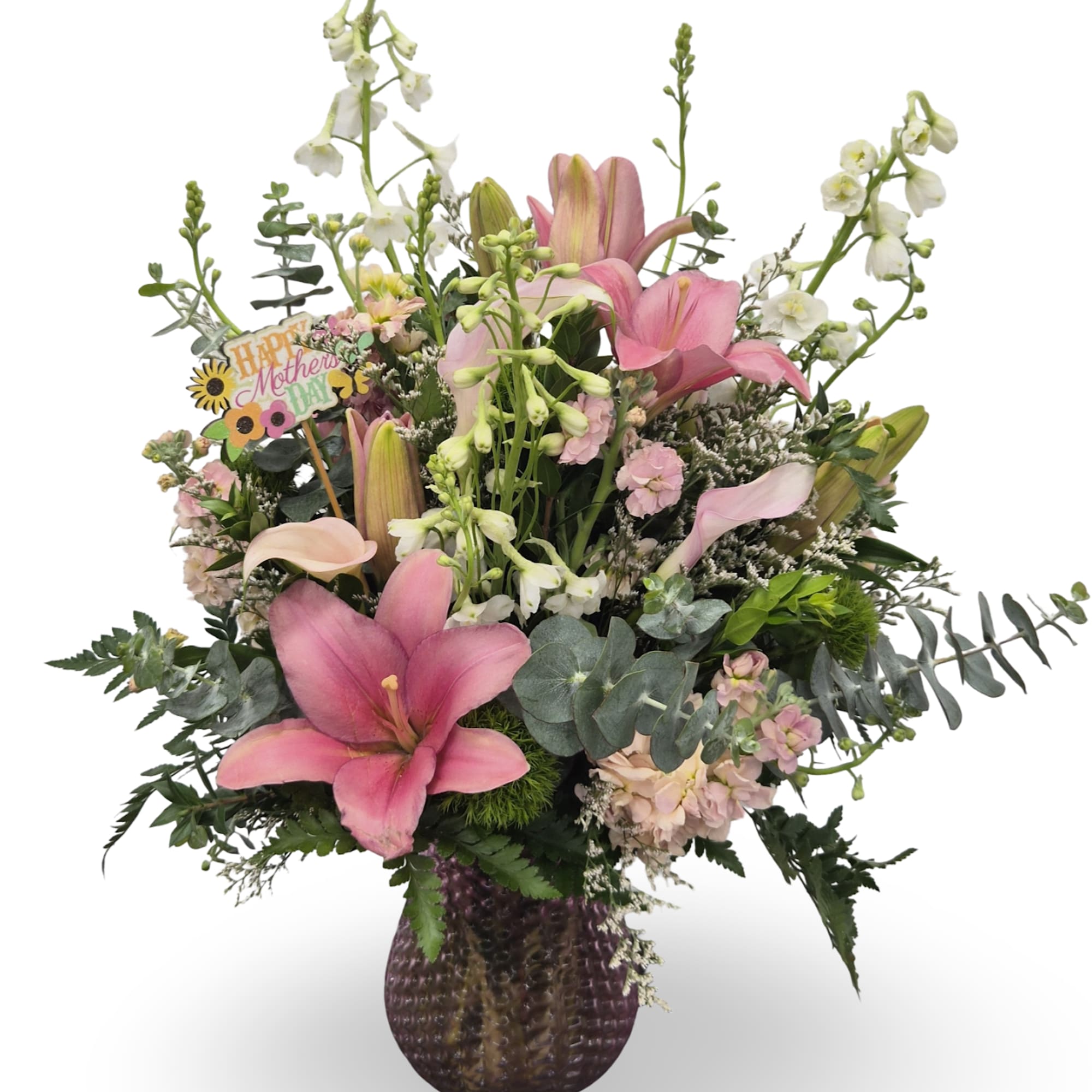 Soft pink lilies take center stage in this garden-style flower arrangement, a