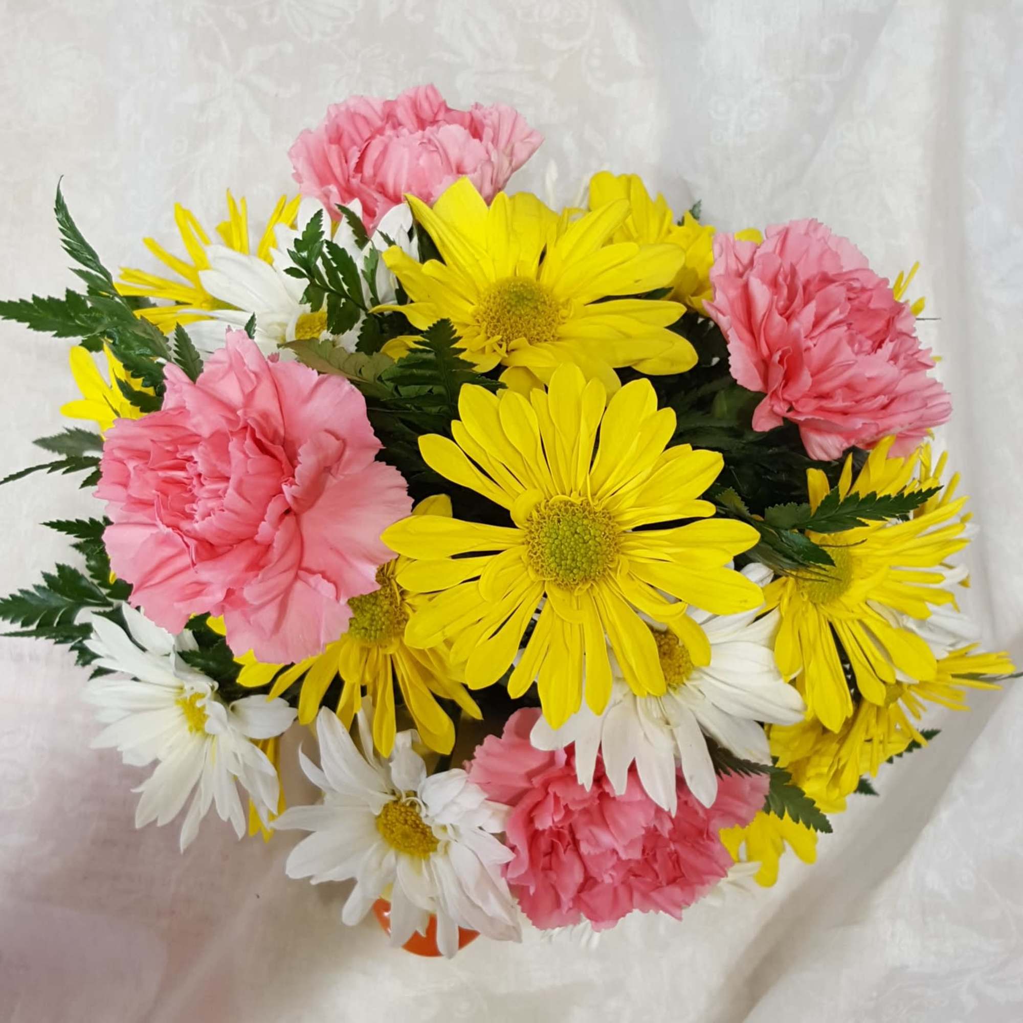 Bouquet of pink carnations and yellow and white daisies