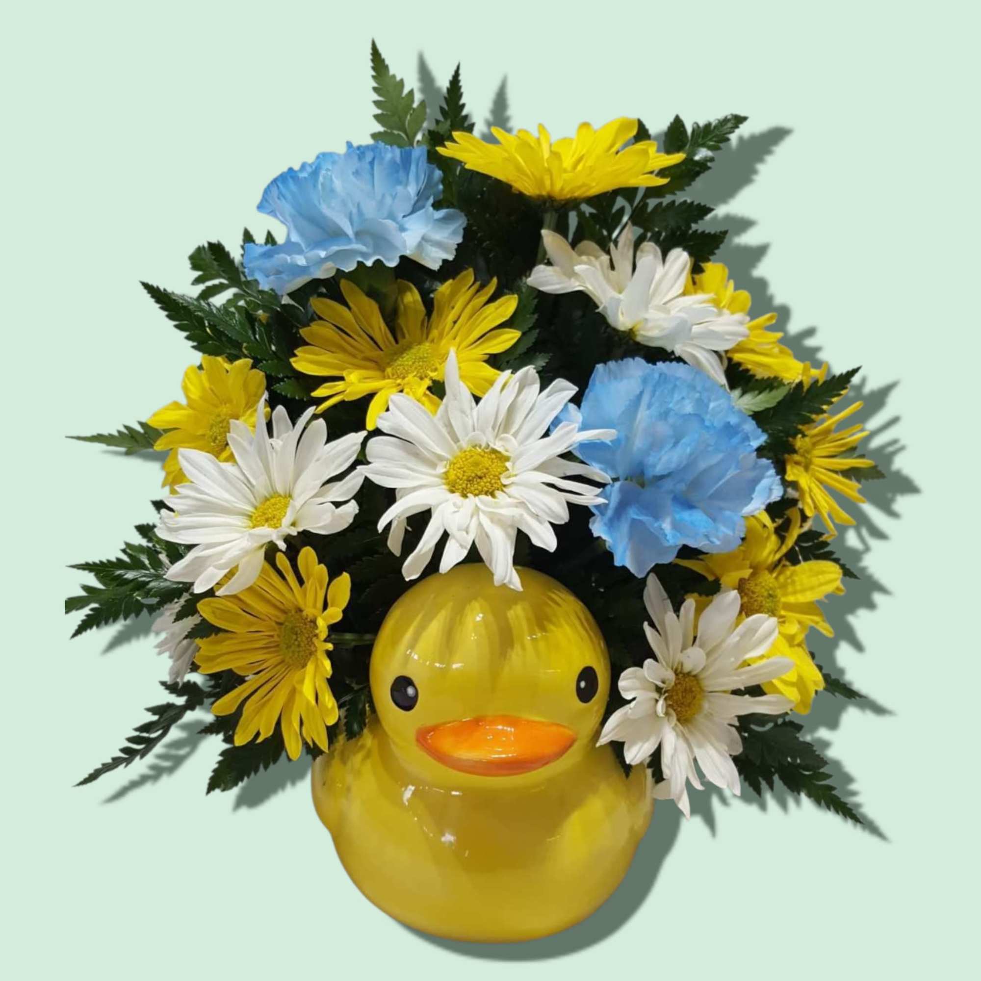 A whimsical ceramic duck planter is home to long lasting carnations and
