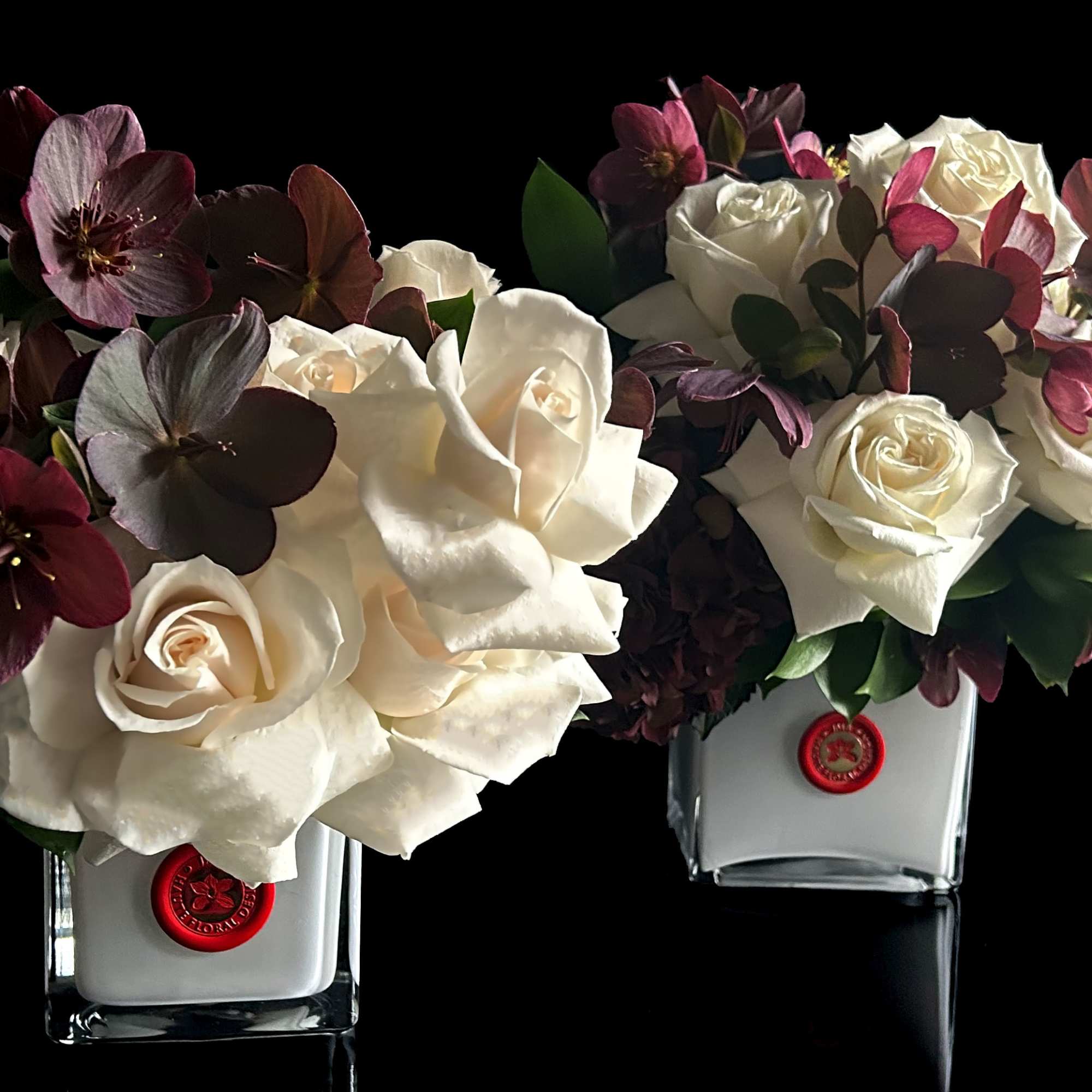 Roses and Hellebores in white glass vase.