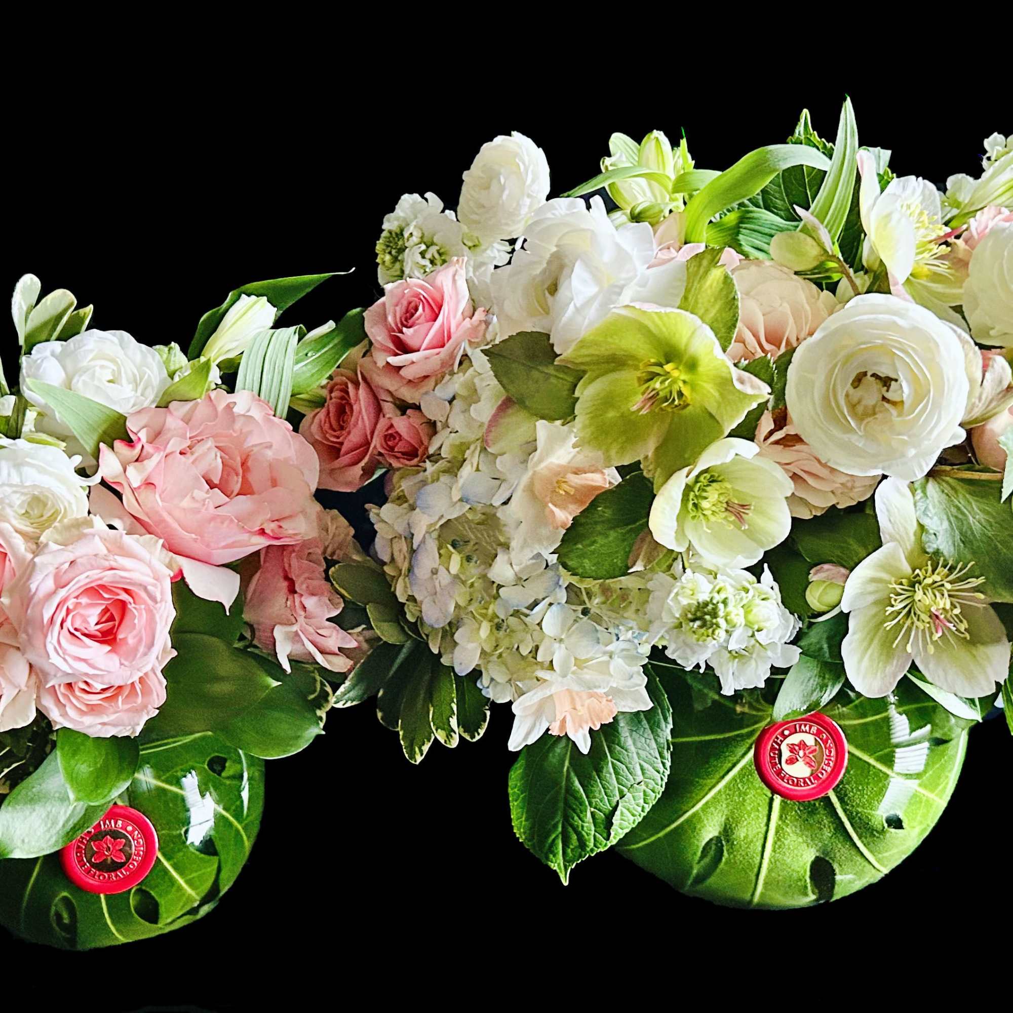 Pink and white floral arrangements in green watermelon-shaped containers
