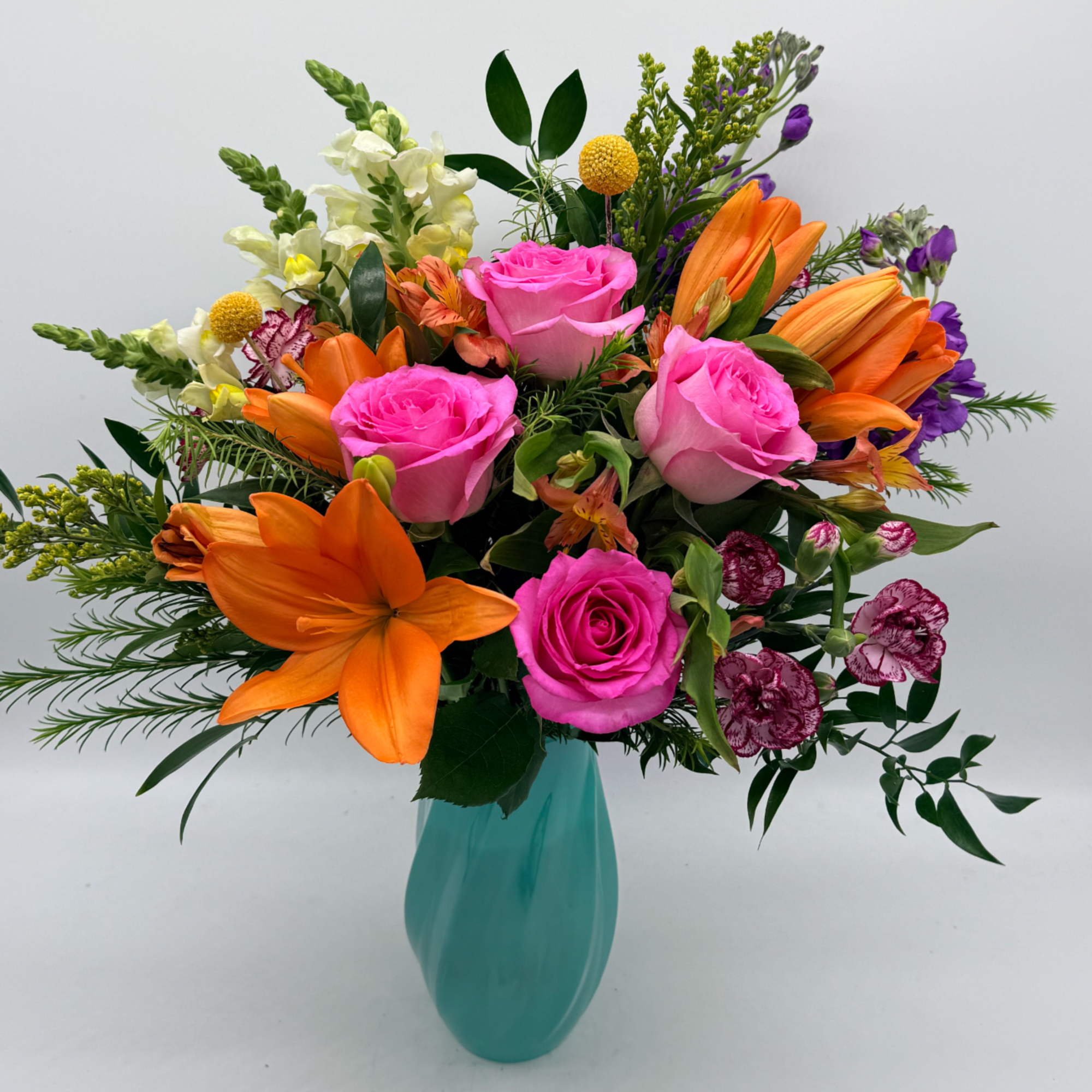 A vibrant, feel-good arrangement bursting with color and charm.
Designed in a soft