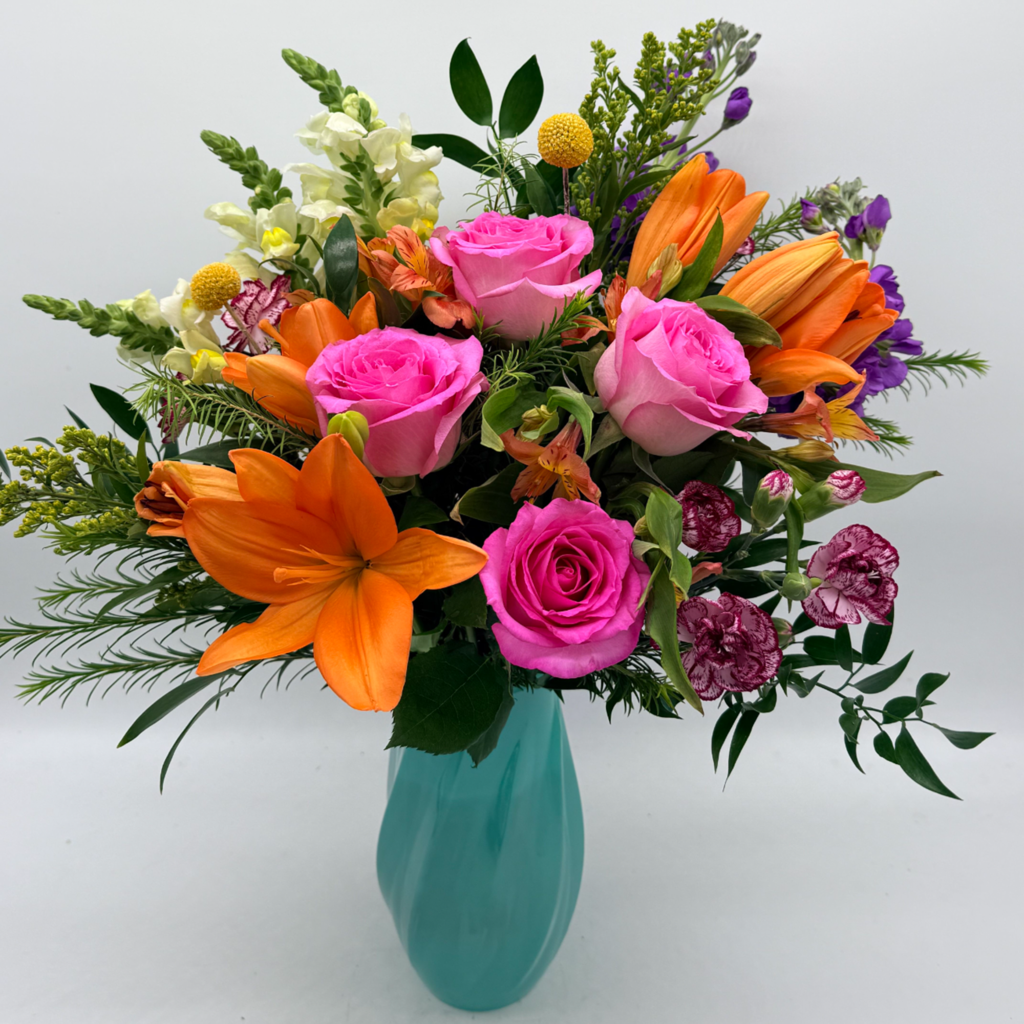 A vibrant, feel-good arrangement bursting with color and charm.
Designed in a soft