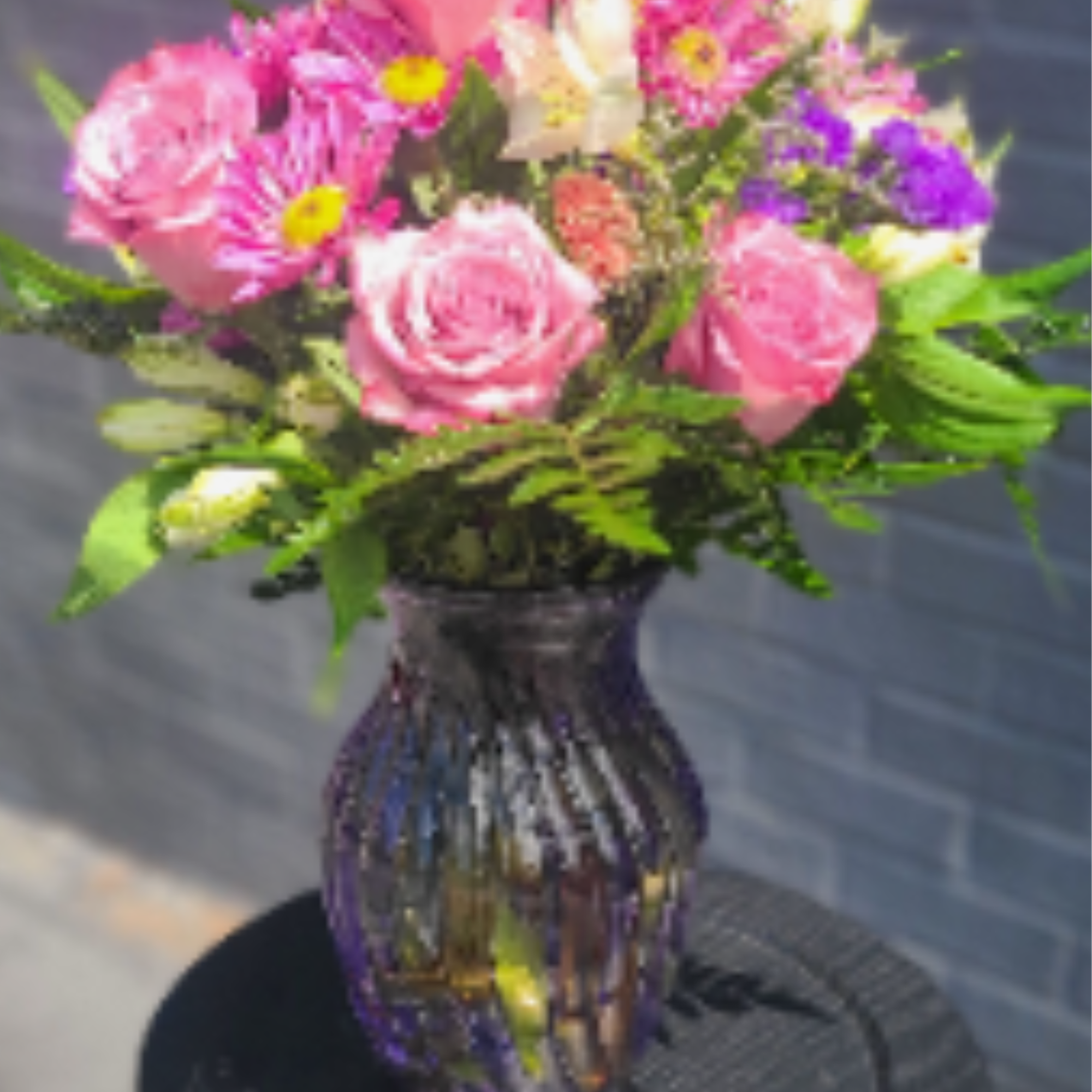 Soft pink roses and vivid magenta daisies mingle with white alstroemeria and