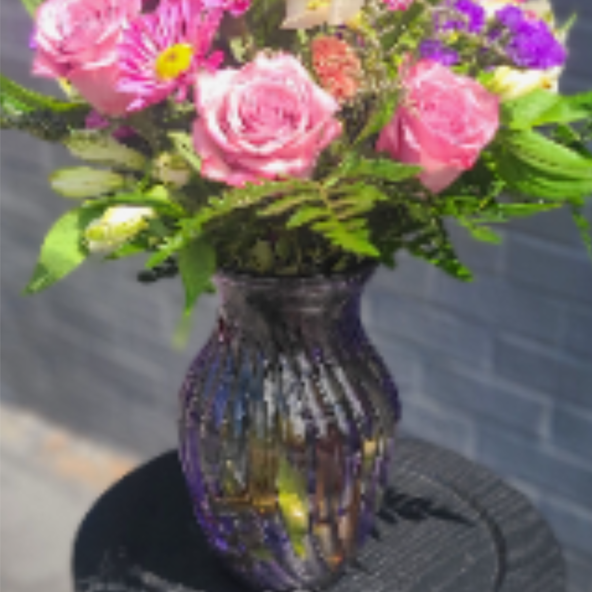 Soft pink roses and vivid magenta daisies mingle with white alstroemeria and