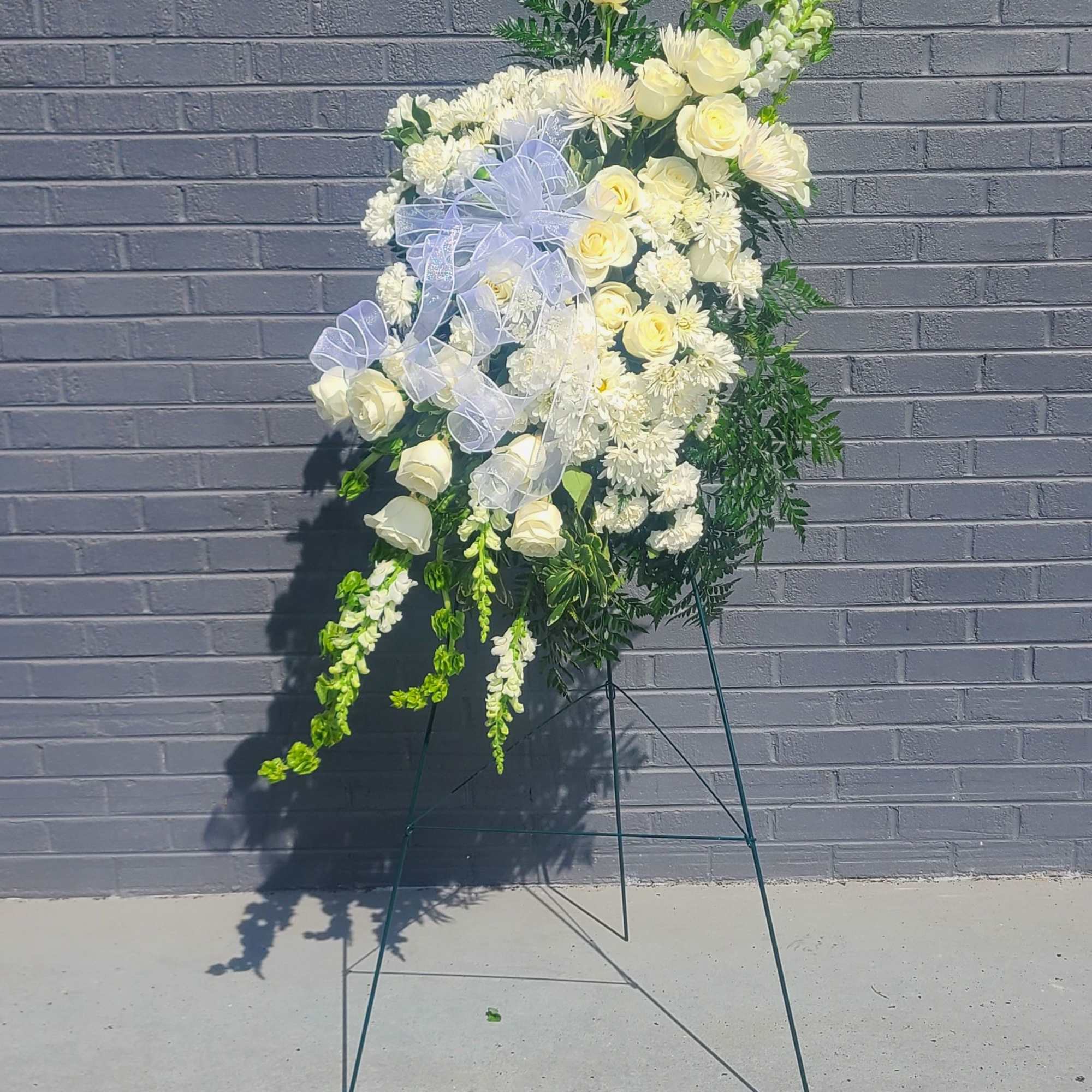 Pure white roses and clusters of daisy-like chrysanthemums form a serene, vertical