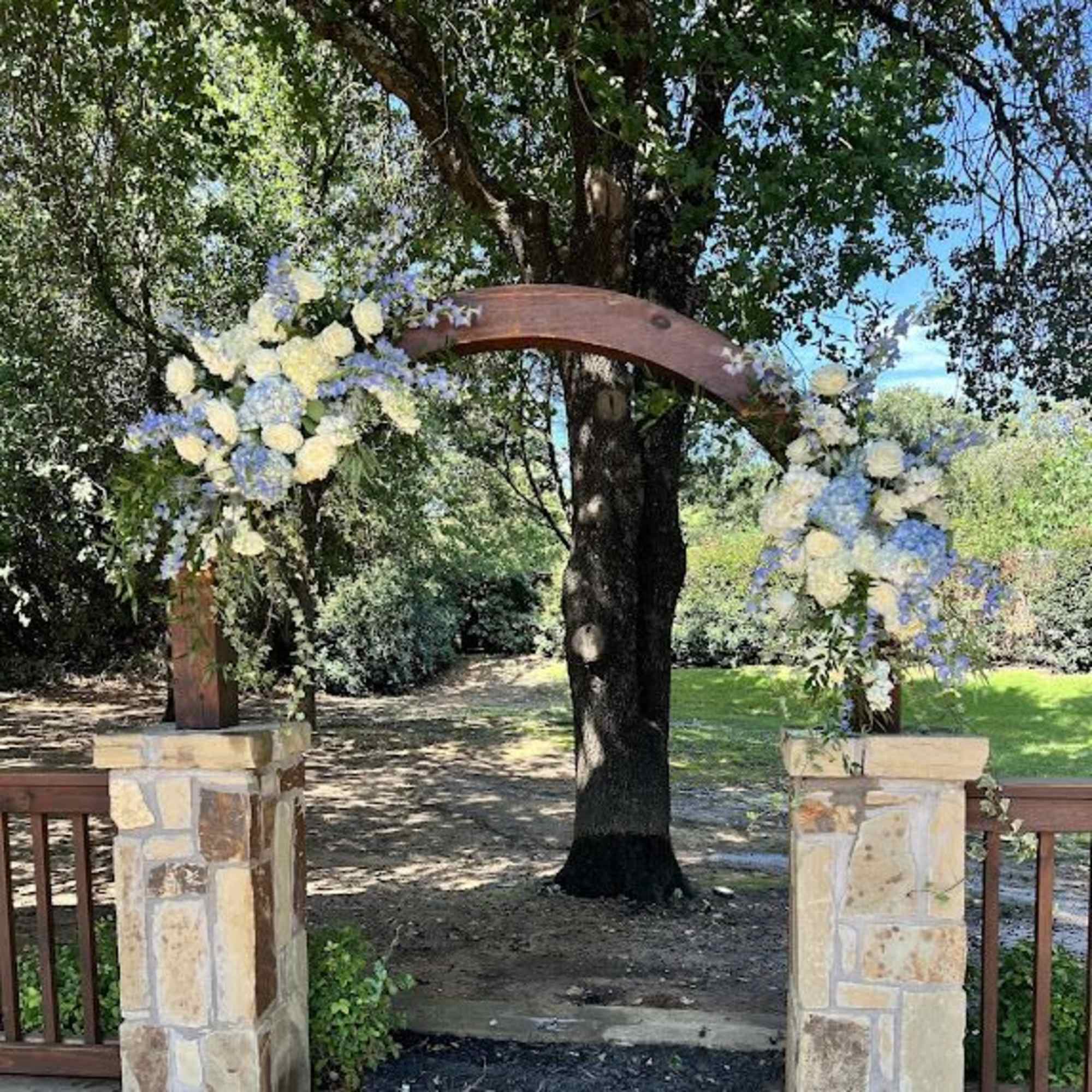 Floral arch with blue and white flowers outdoors