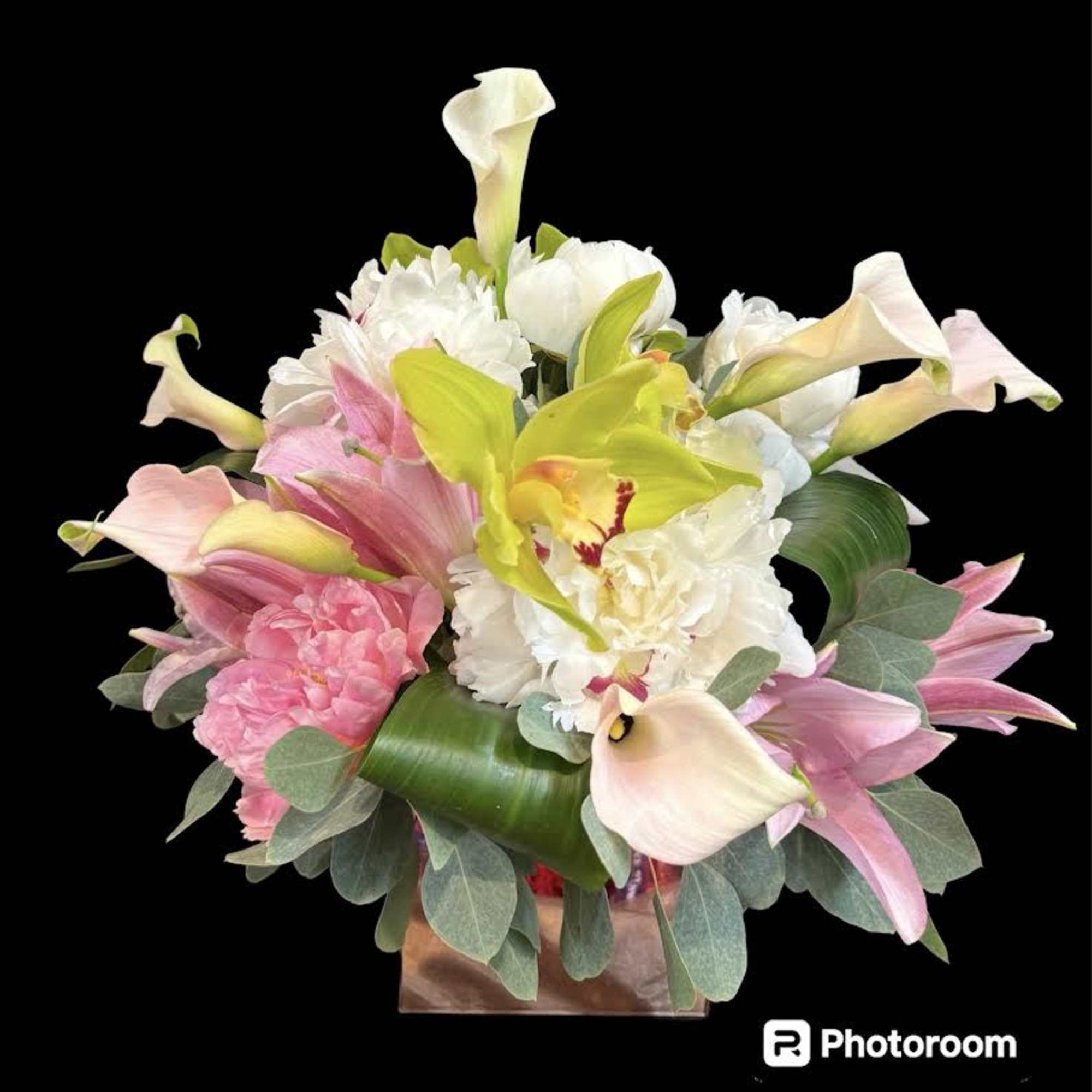 Bouquet of pink and white flowers with calla lilies in a box