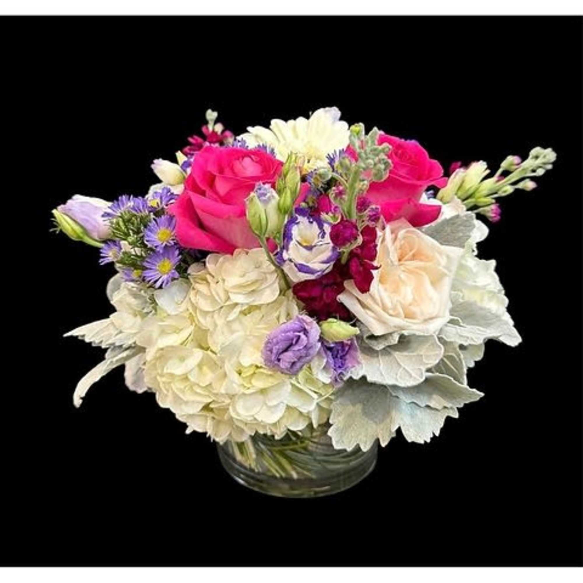 Bouquet of pink and white flowers in a clear glass vase