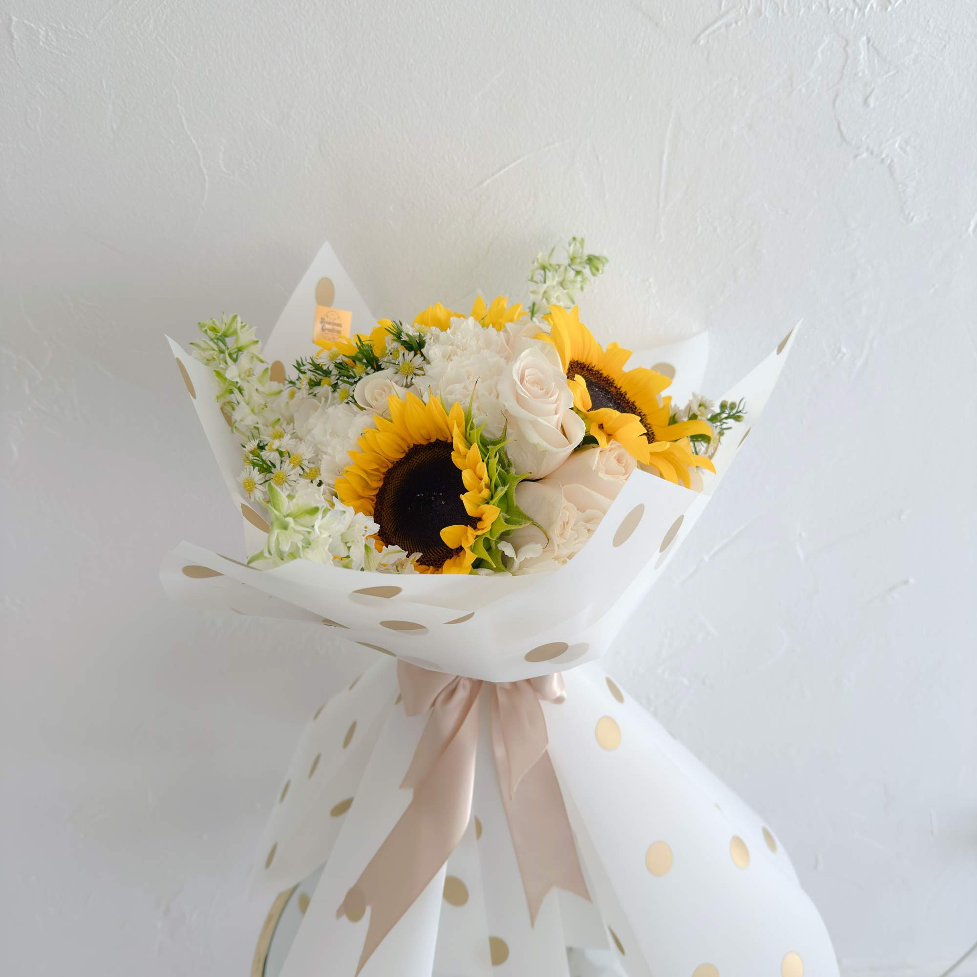 Bright and lively bouquet featuring vibrant sunflowers as the focal point, complemented
