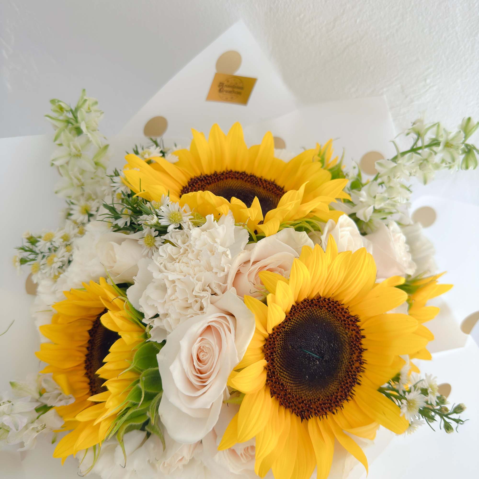 Bright and lively bouquet featuring vibrant sunflowers as the focal point, complemented