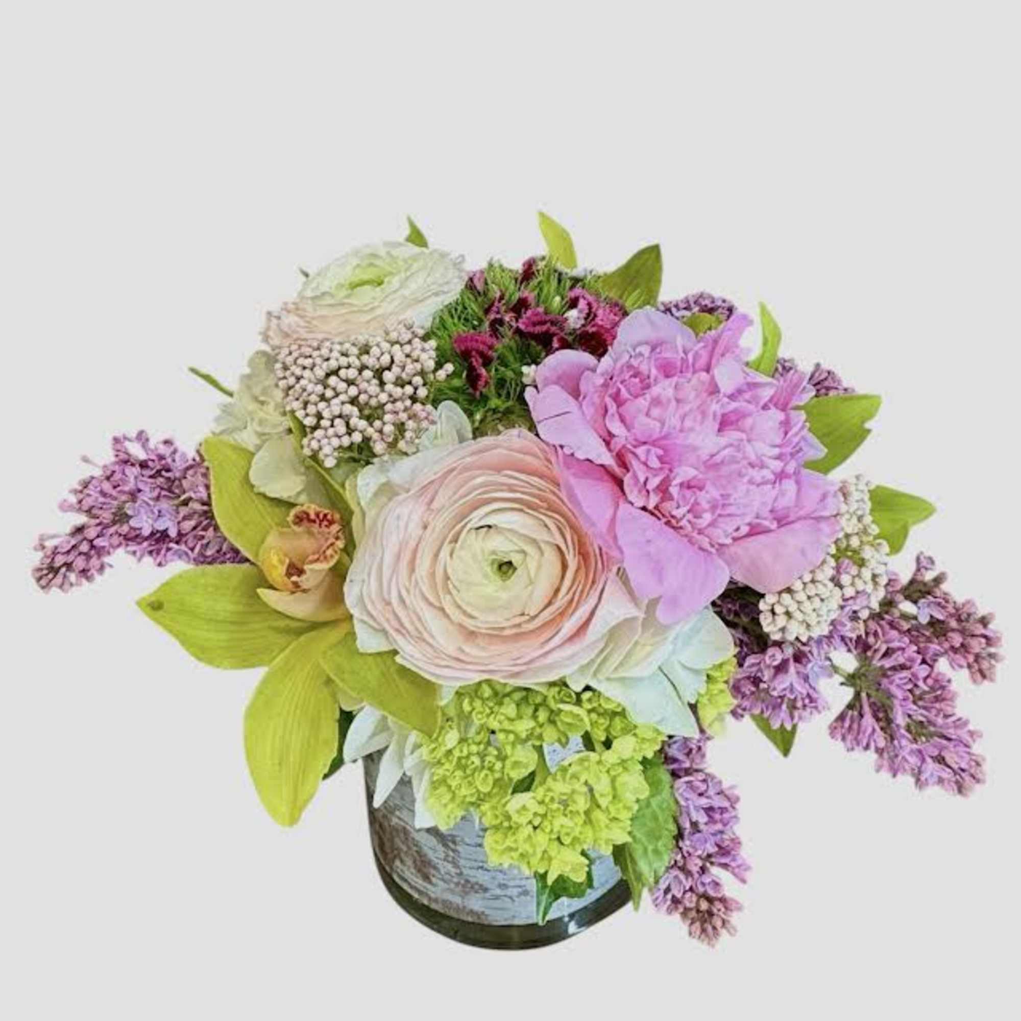 Pastel floral arrangement in a vase with pink and lavender blooms