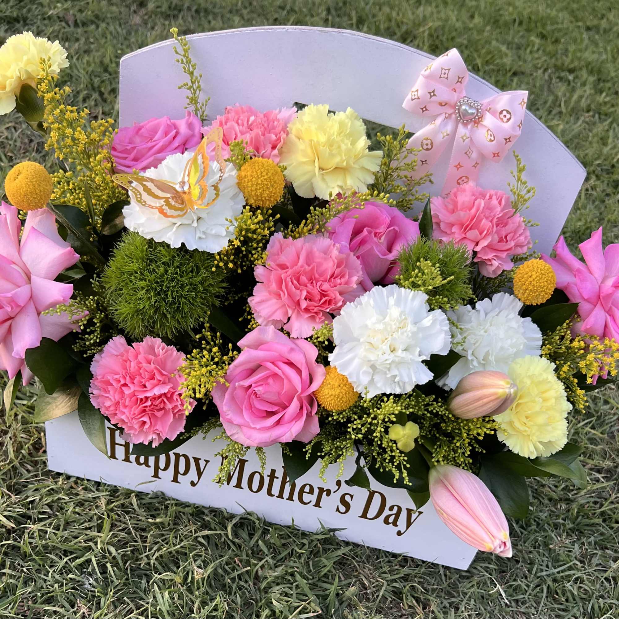 A vibrant mix of pink, white, and yellow blooms, beautifully arranged to