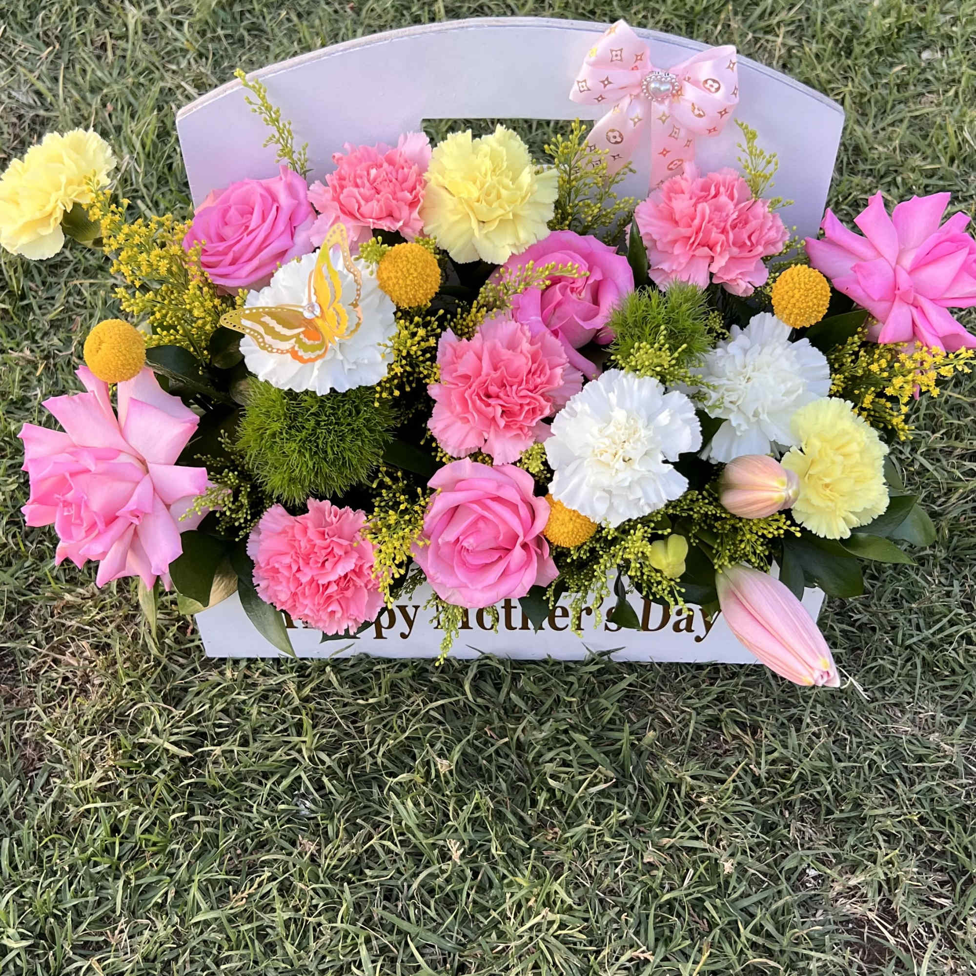 A vibrant mix of pink, white, and yellow blooms, beautifully arranged to