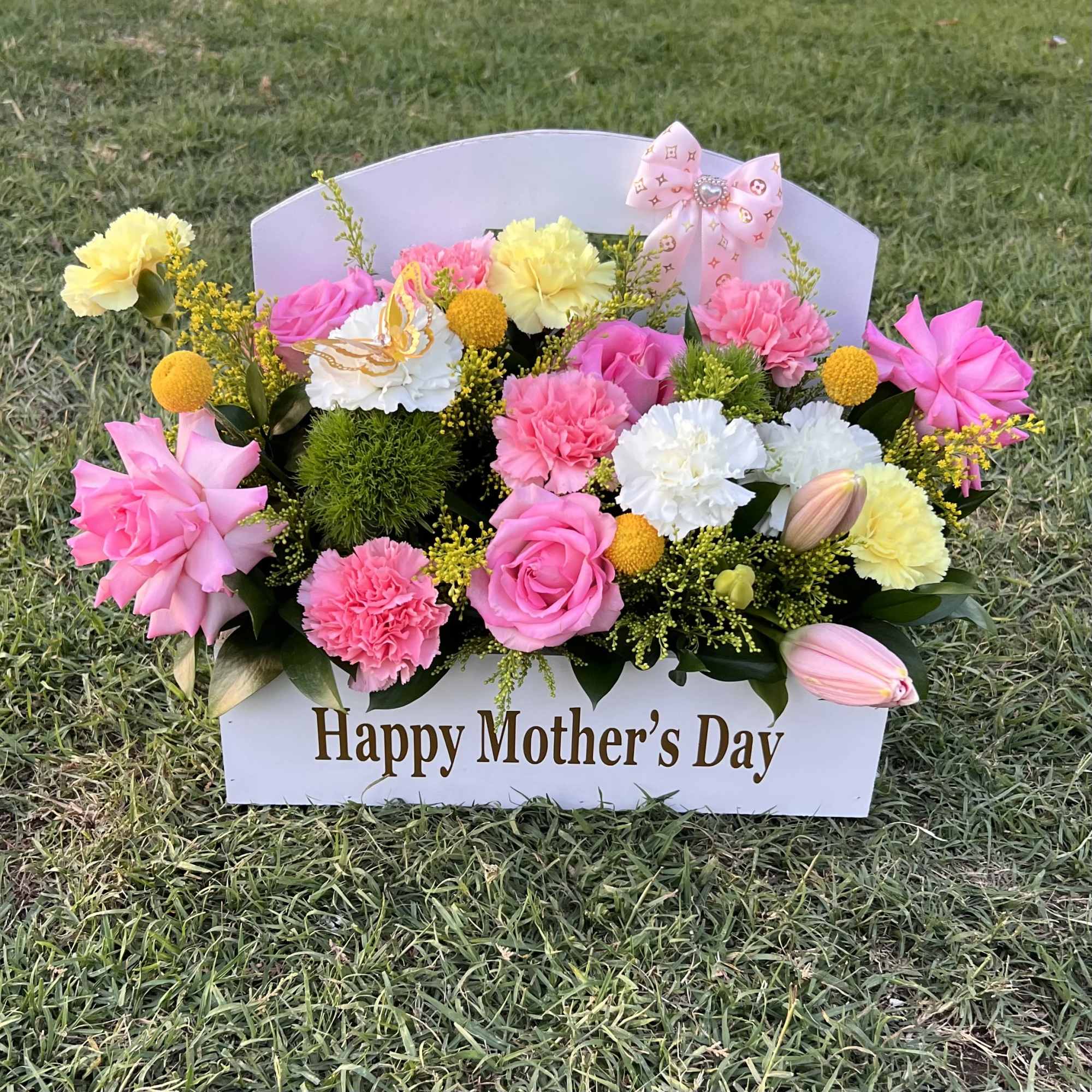 A vibrant mix of pink, white, and yellow blooms, beautifully arranged to