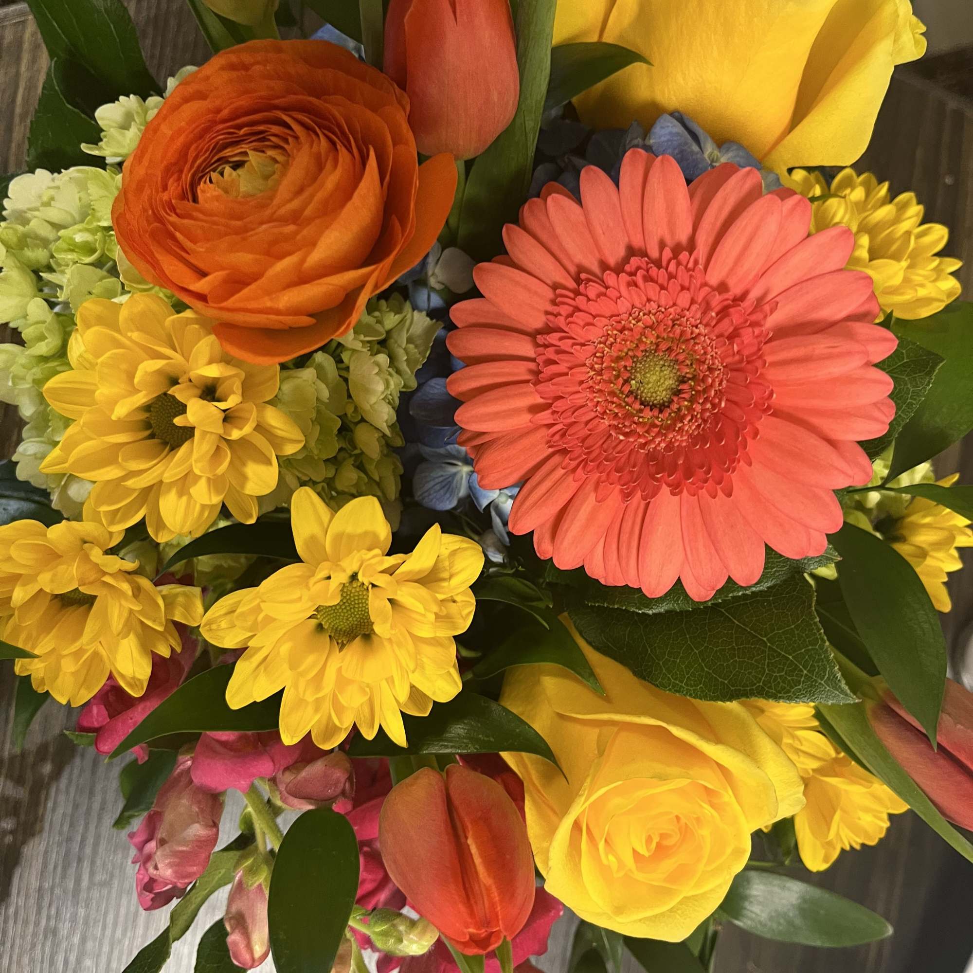 Just picked from the garden flowers in a cylinder or cube vase.
We