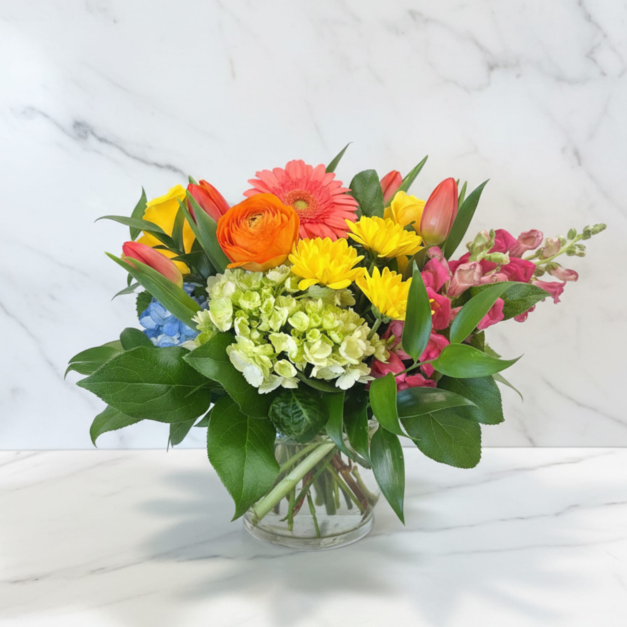 Just picked from the garden flowers in a cylinder or cube vase.
We