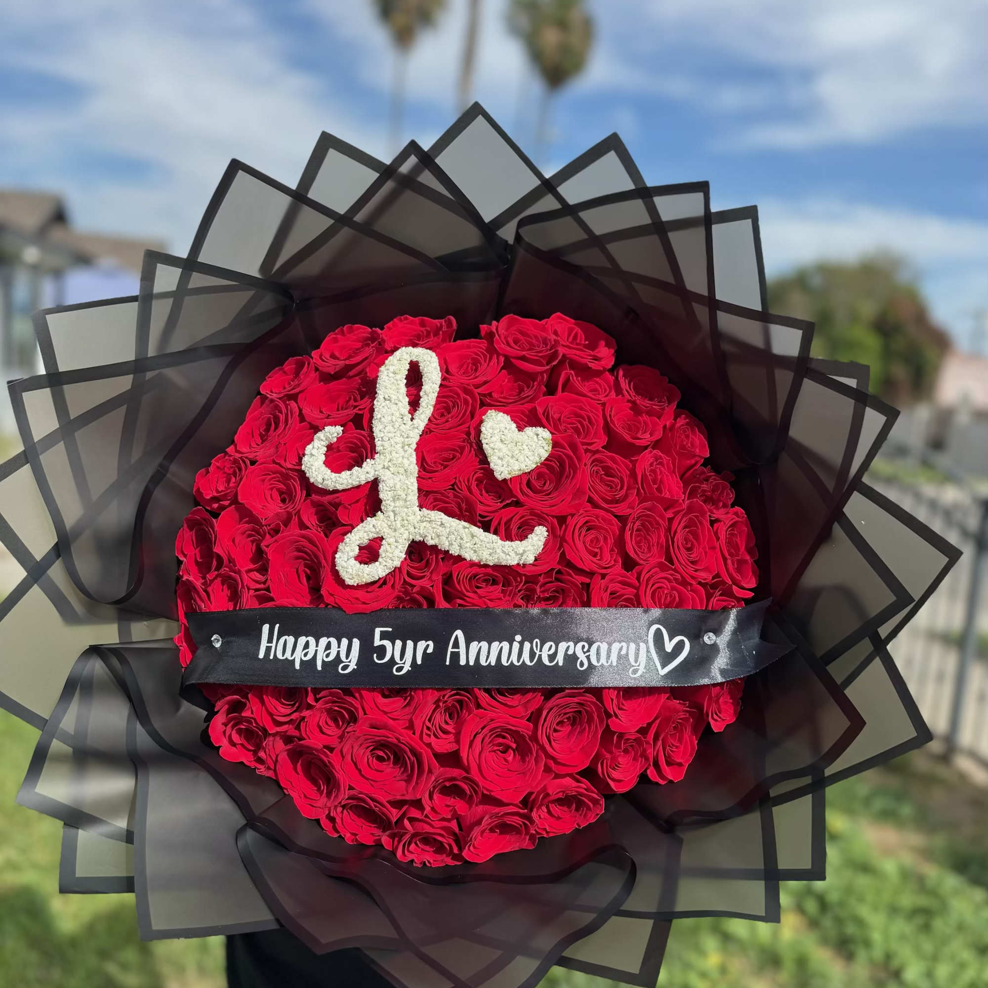 Red roses with your choice of baby&rsquo;s breath letter and personalized ribbon.
