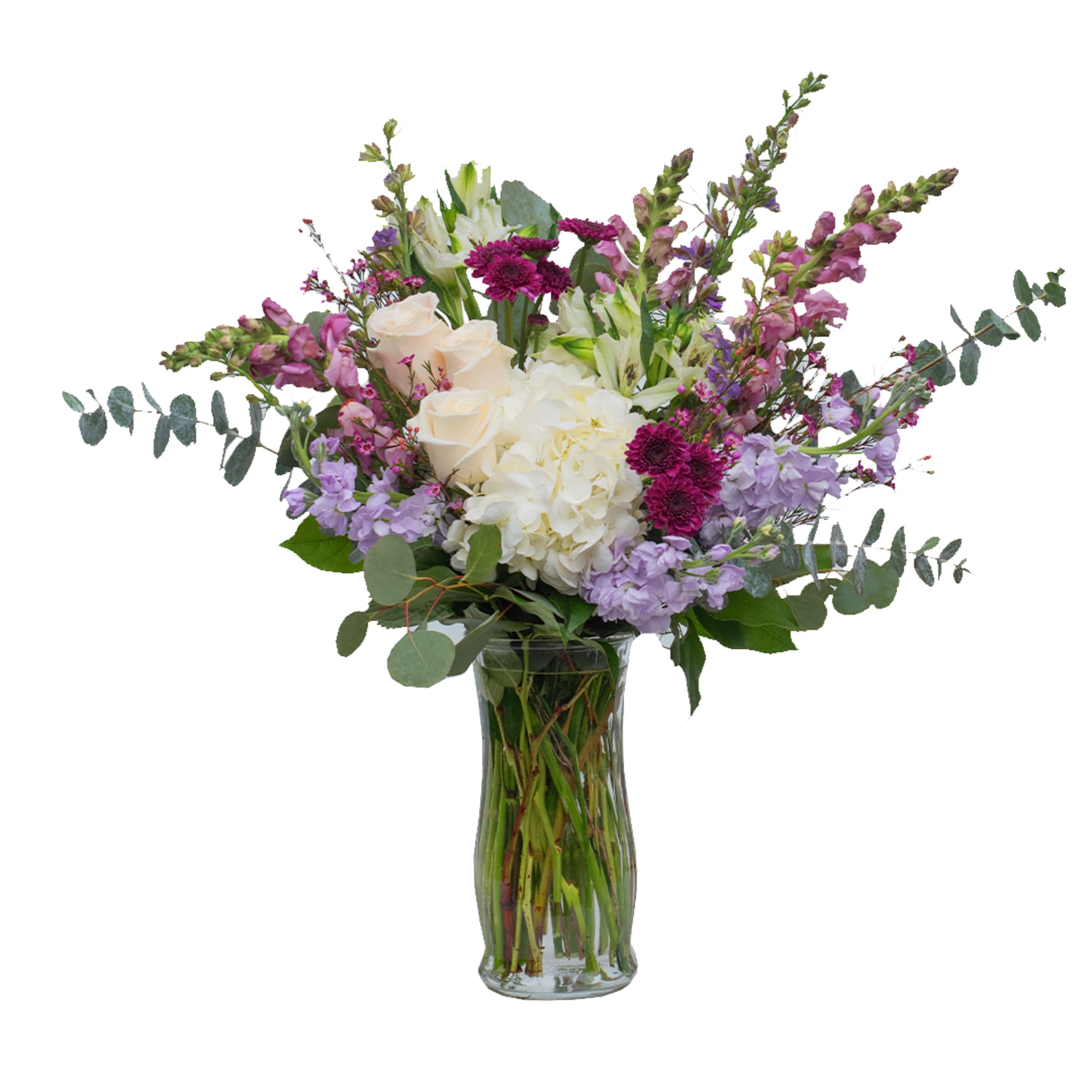 Mixed bouquet of white and purple flowers in a glass vase