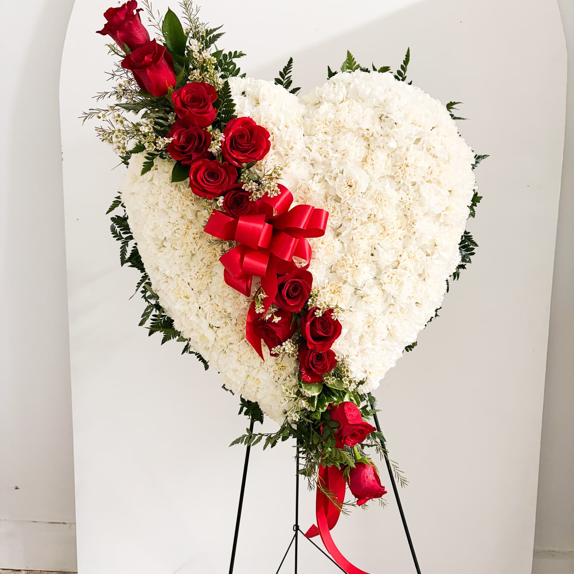A timeless and elegant standing spray, this arrangement showcases a beautiful harmony