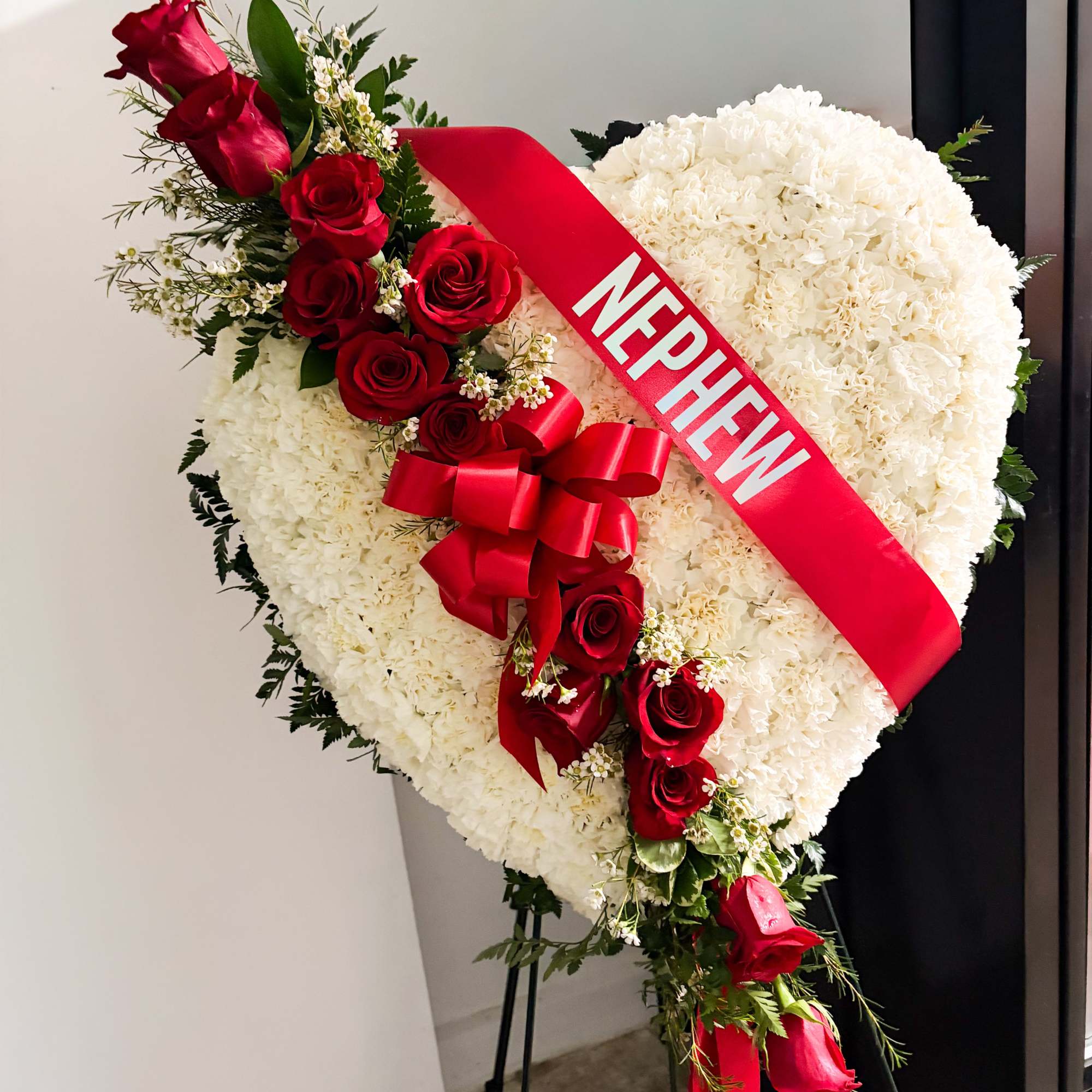 A timeless and elegant standing spray, this arrangement showcases a beautiful harmony