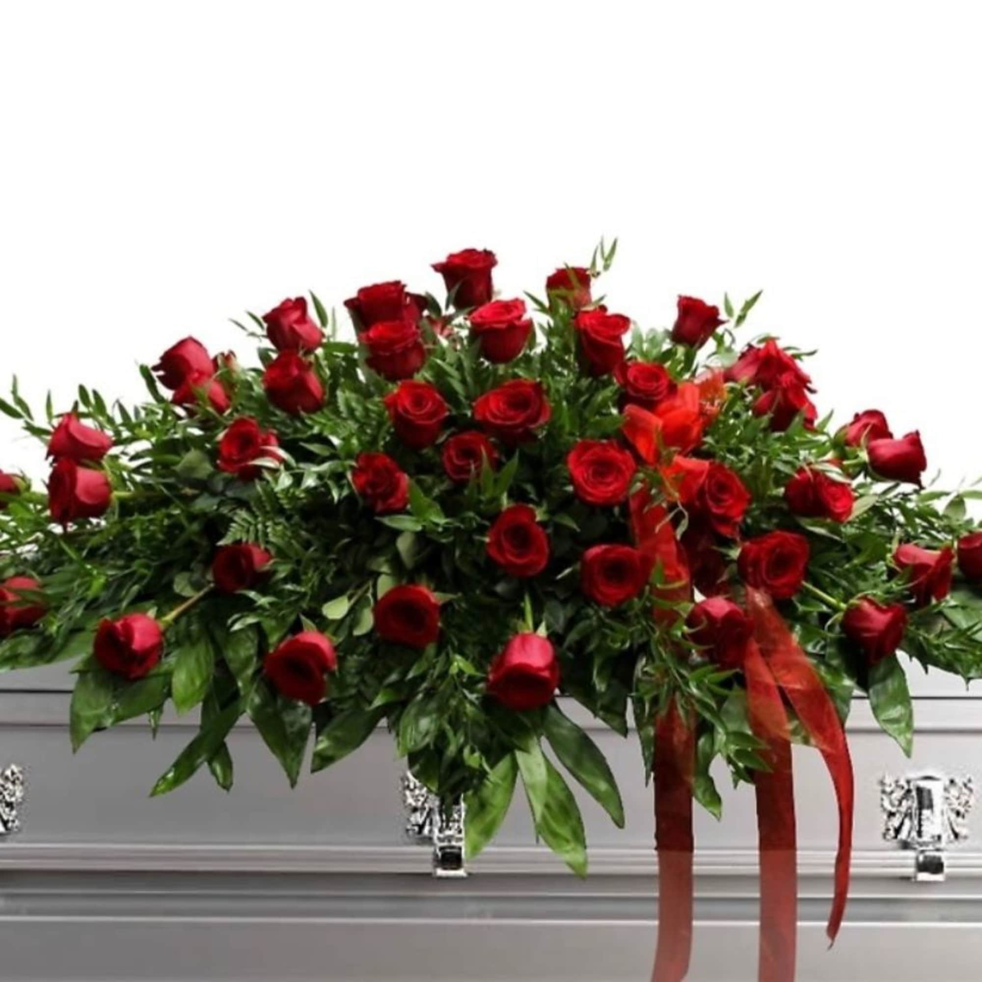 A classic cascade of deep red roses arranged in a large, low