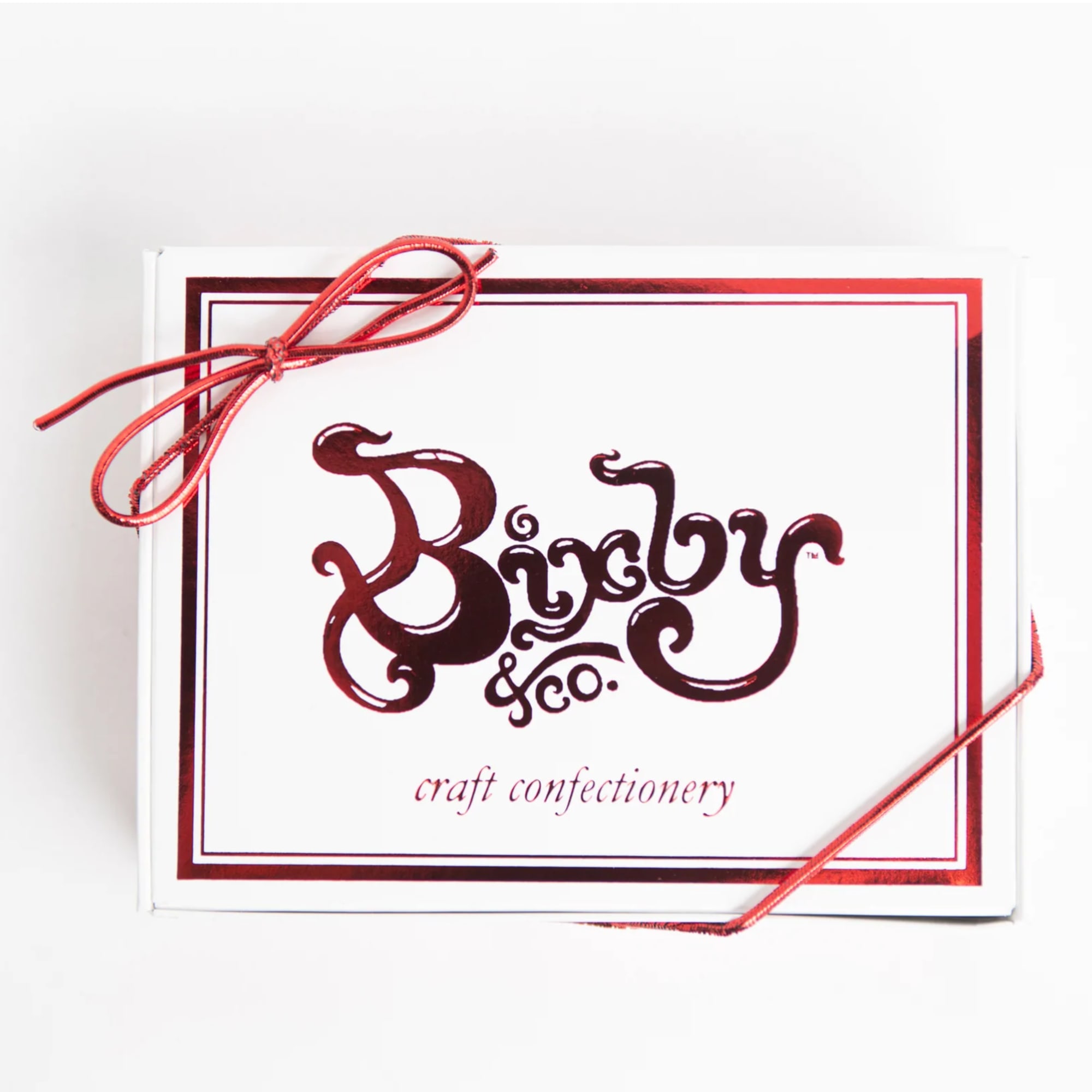 White craft confectionery gift box with red logo and red ribbon bow