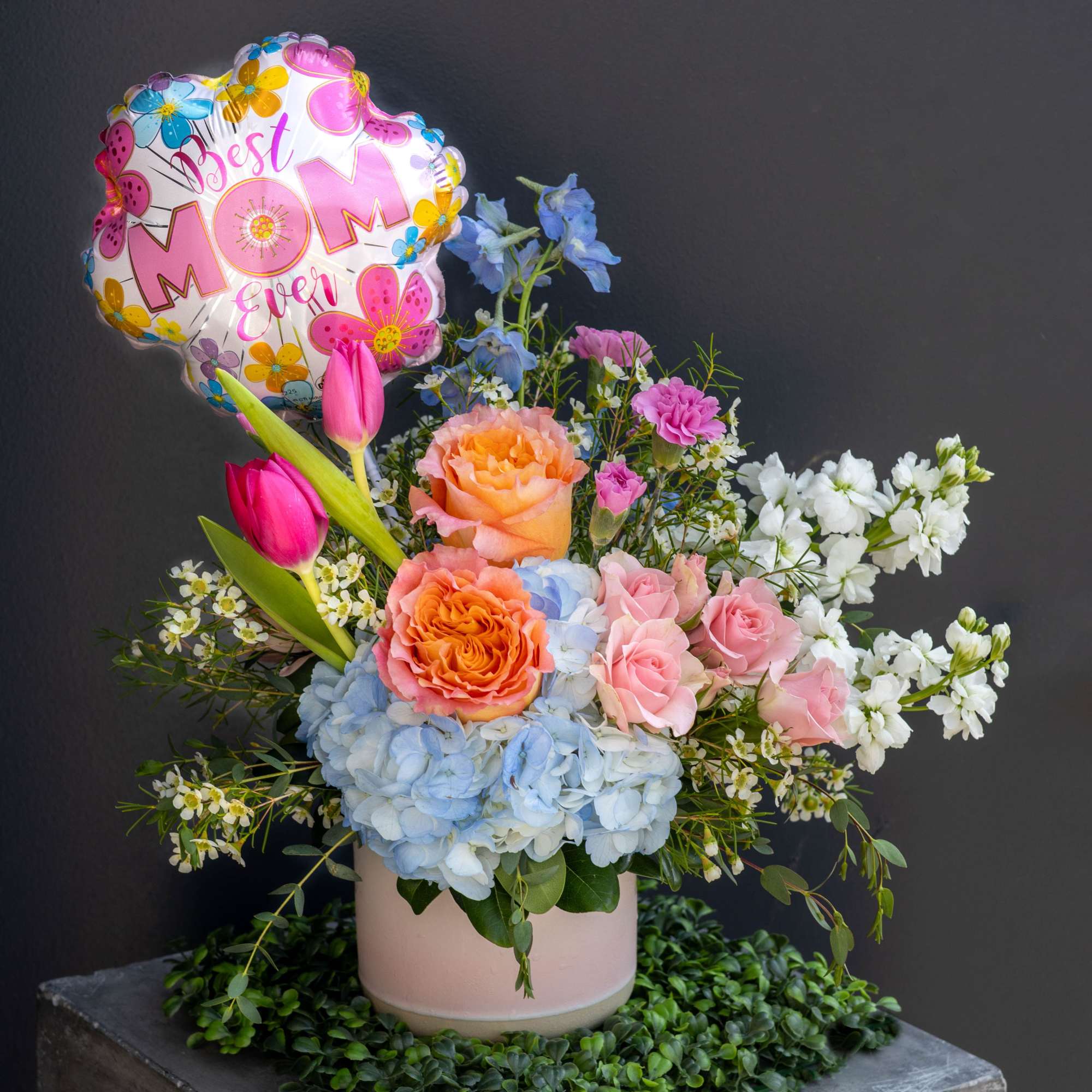A fun bright floral arrangement full of color and life that is
