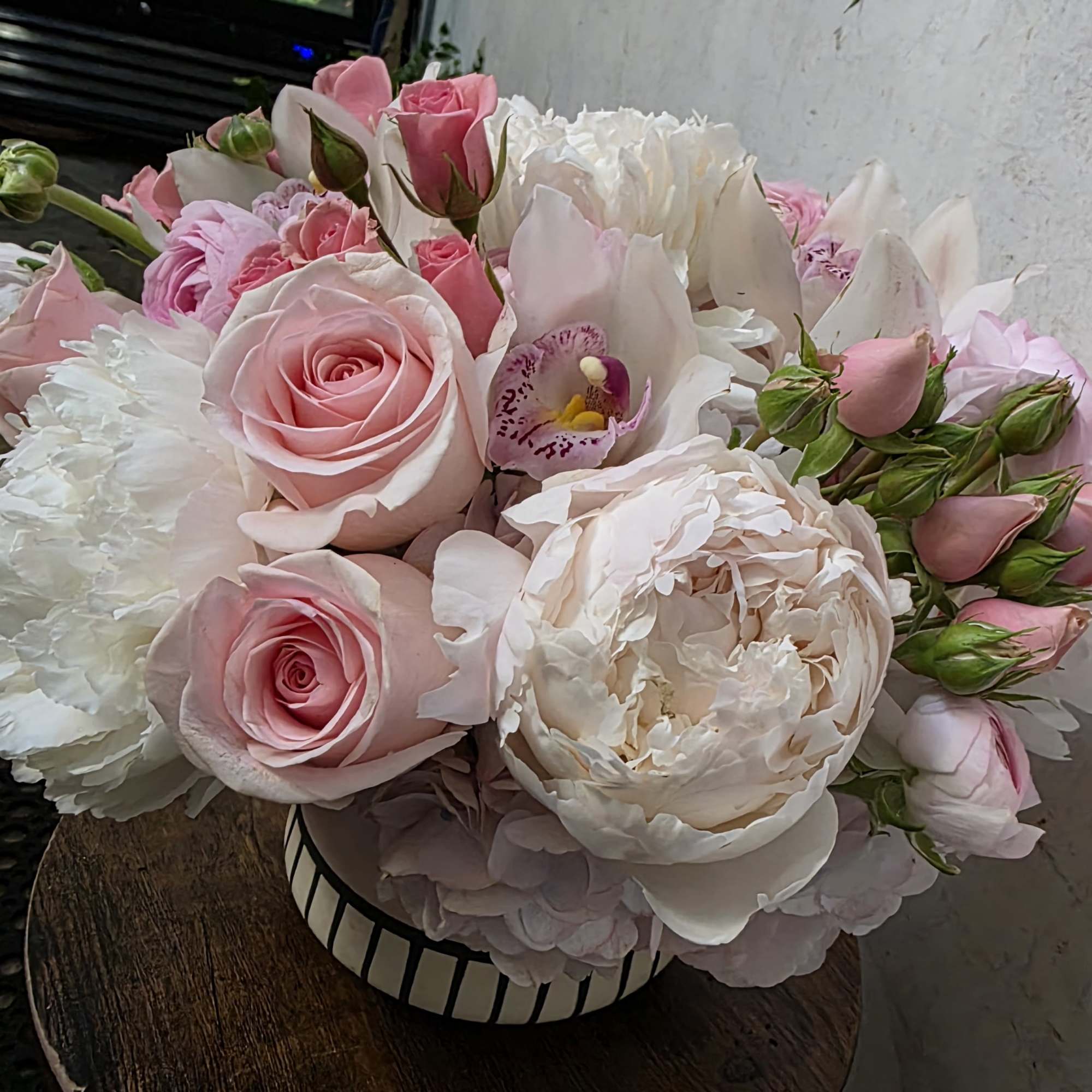 A dreamy mix of premium peonies arranged in a soft, full, and