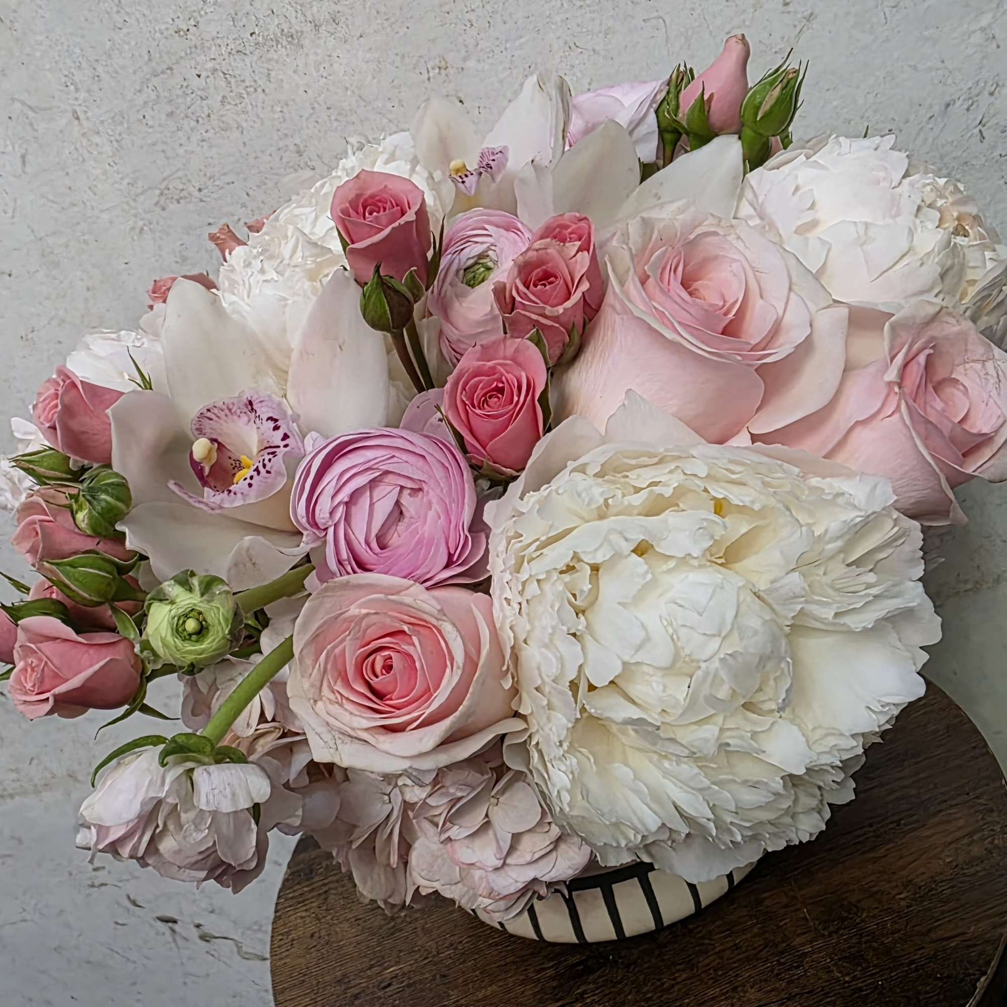 A dreamy mix of premium peonies arranged in a soft, full, and