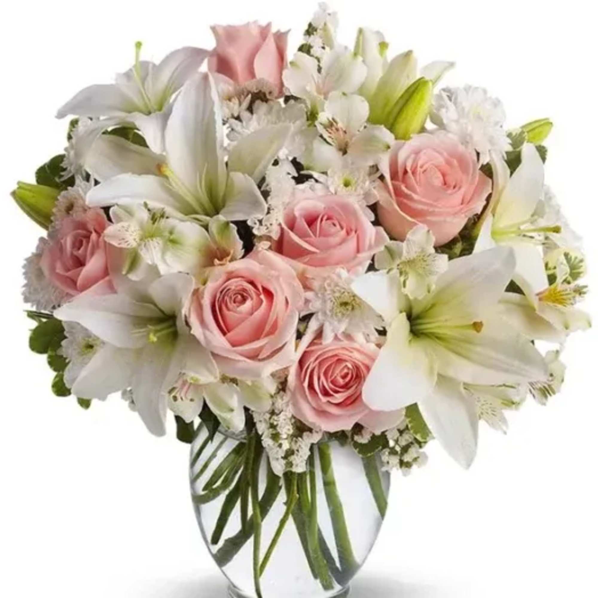 Pink roses and white lilies arranged in a clear glass vase