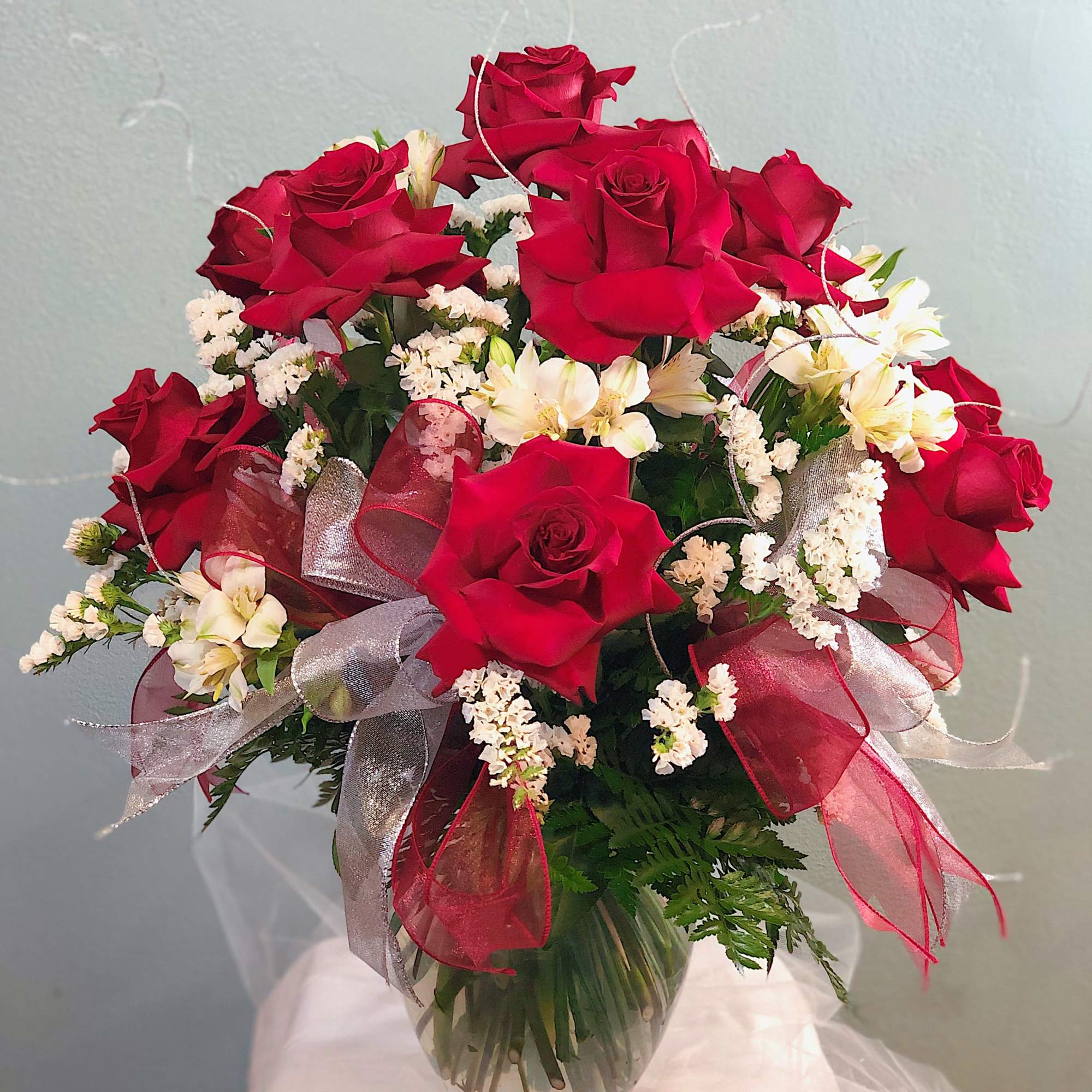 A dozen (12) of red roses styled in a Veronica vase. Red