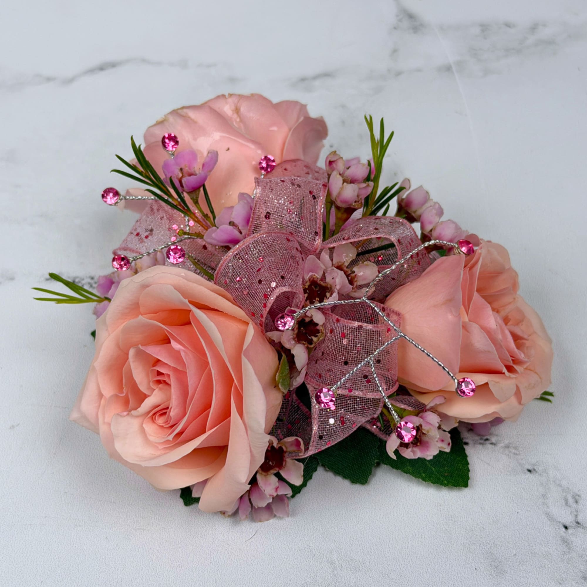 A cluster of blush pink roses accented with tiny pink filler blooms