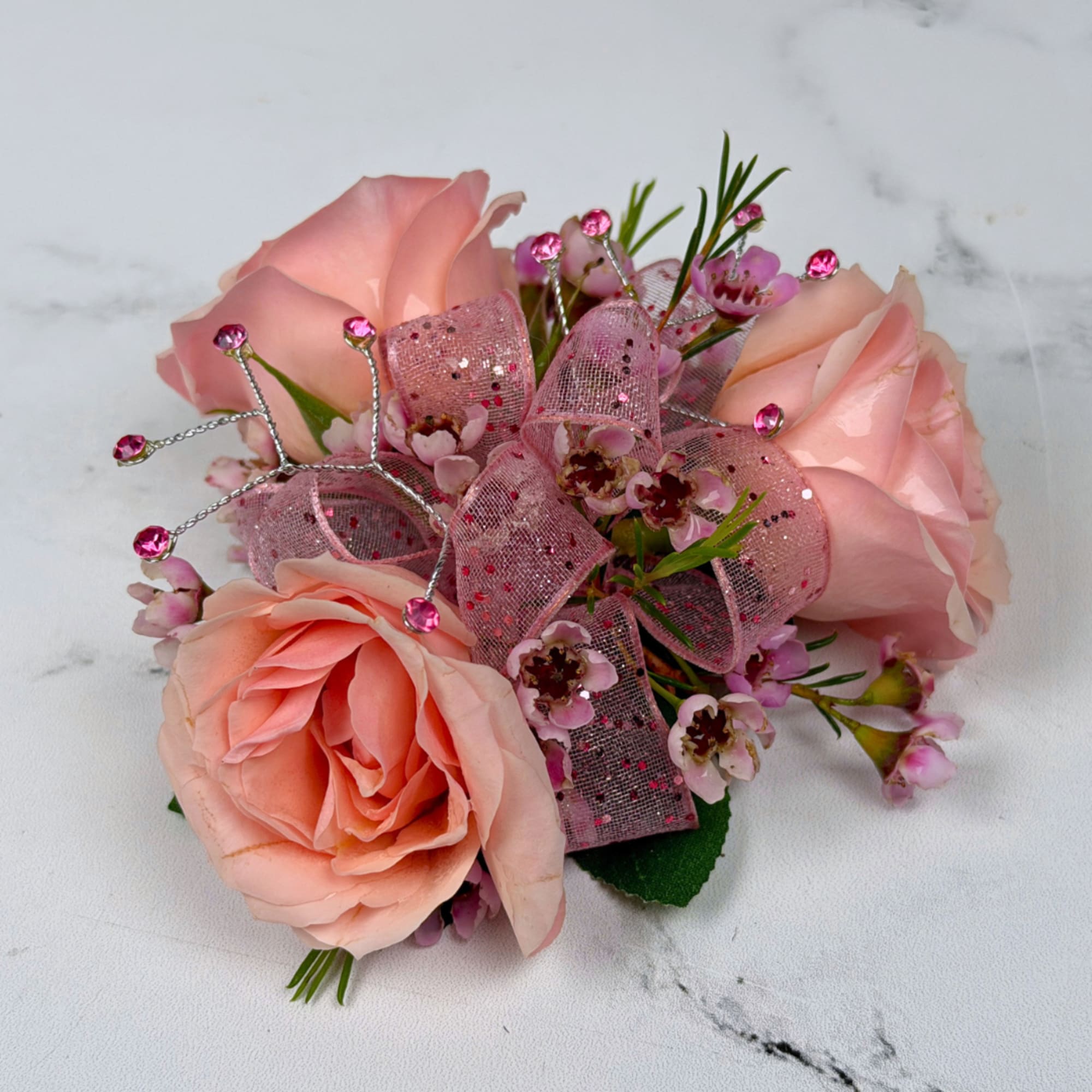 A cluster of blush pink roses accented with tiny pink filler blooms