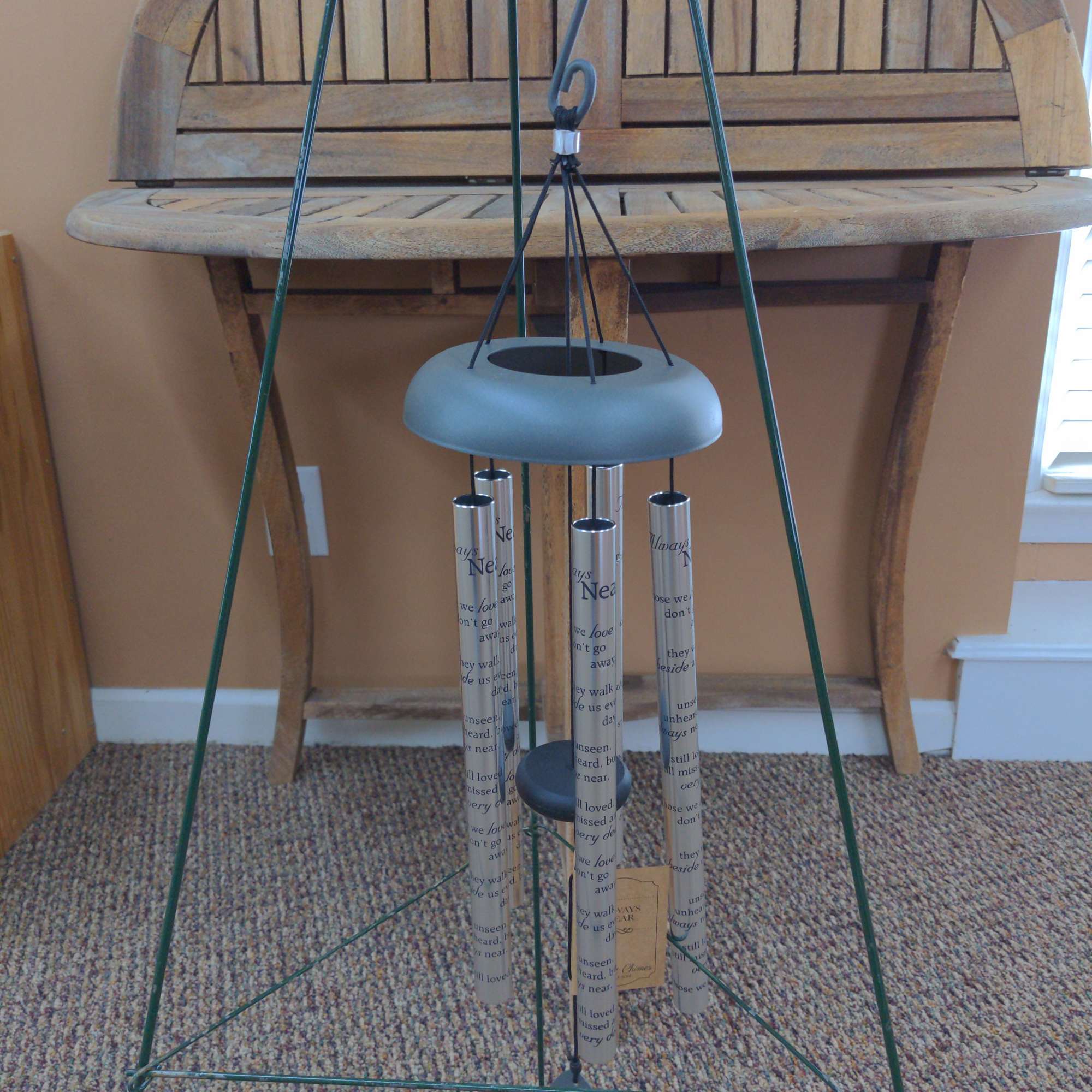 Metal wind chime with printed tubes and a hanging clapper