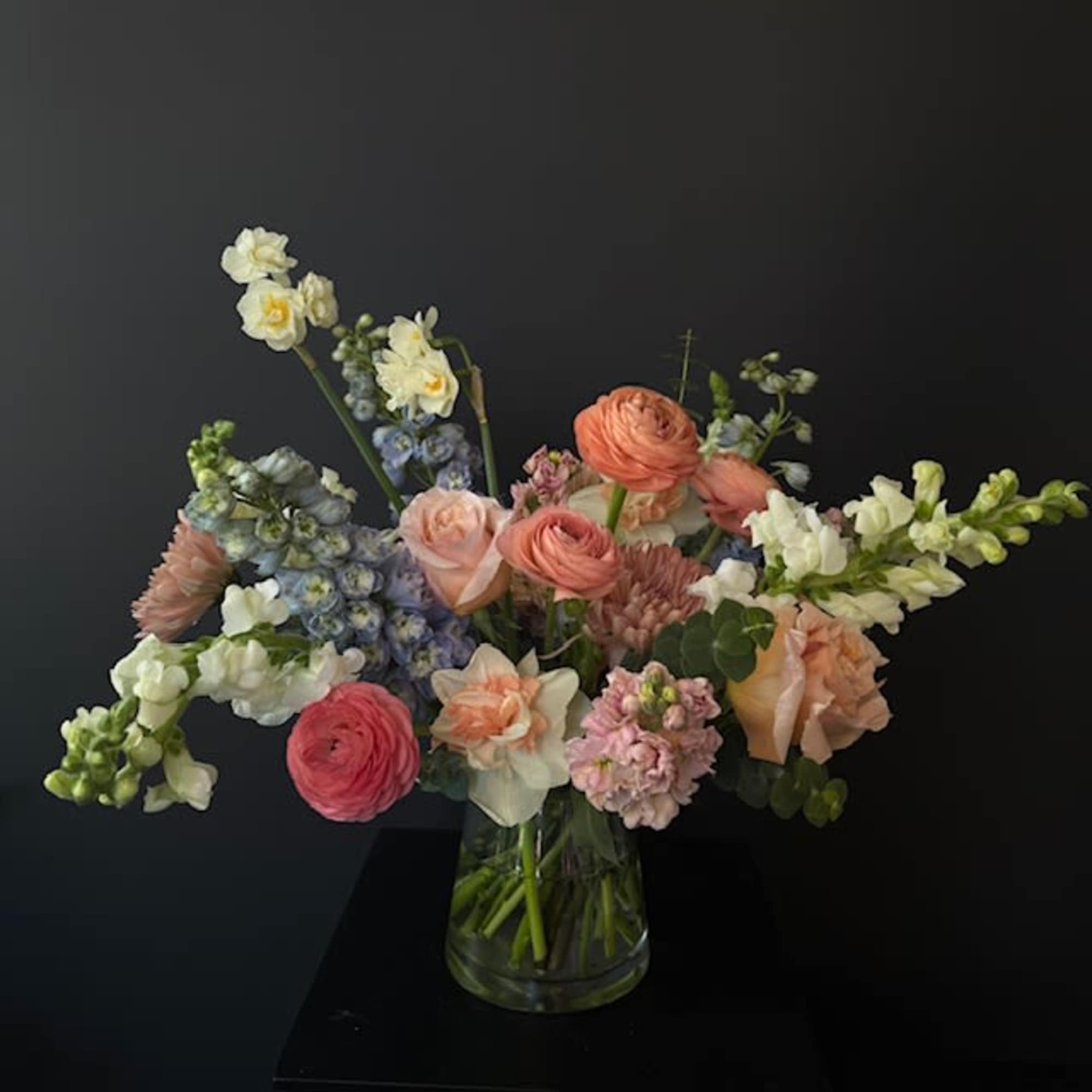Mixed pastel bouquet in a clear glass vase