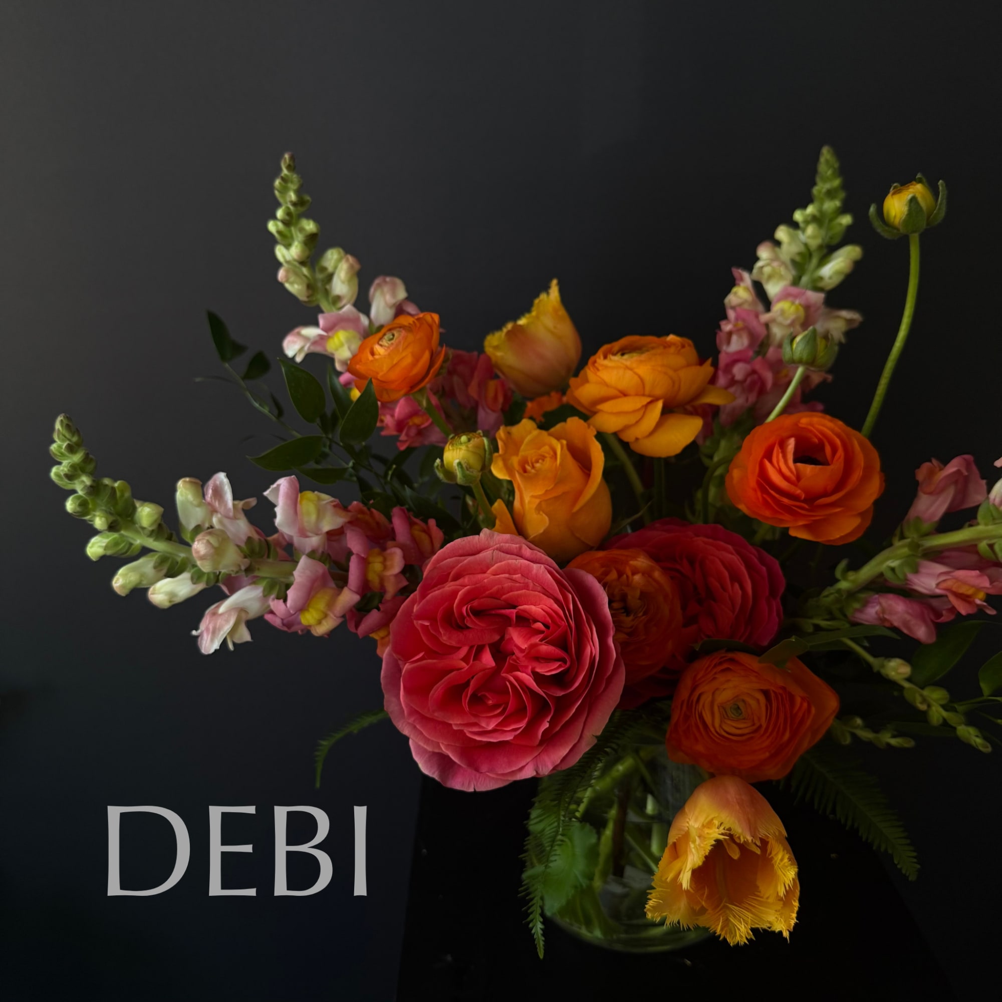 Bouquet of orange and pink flowers in a glass vase