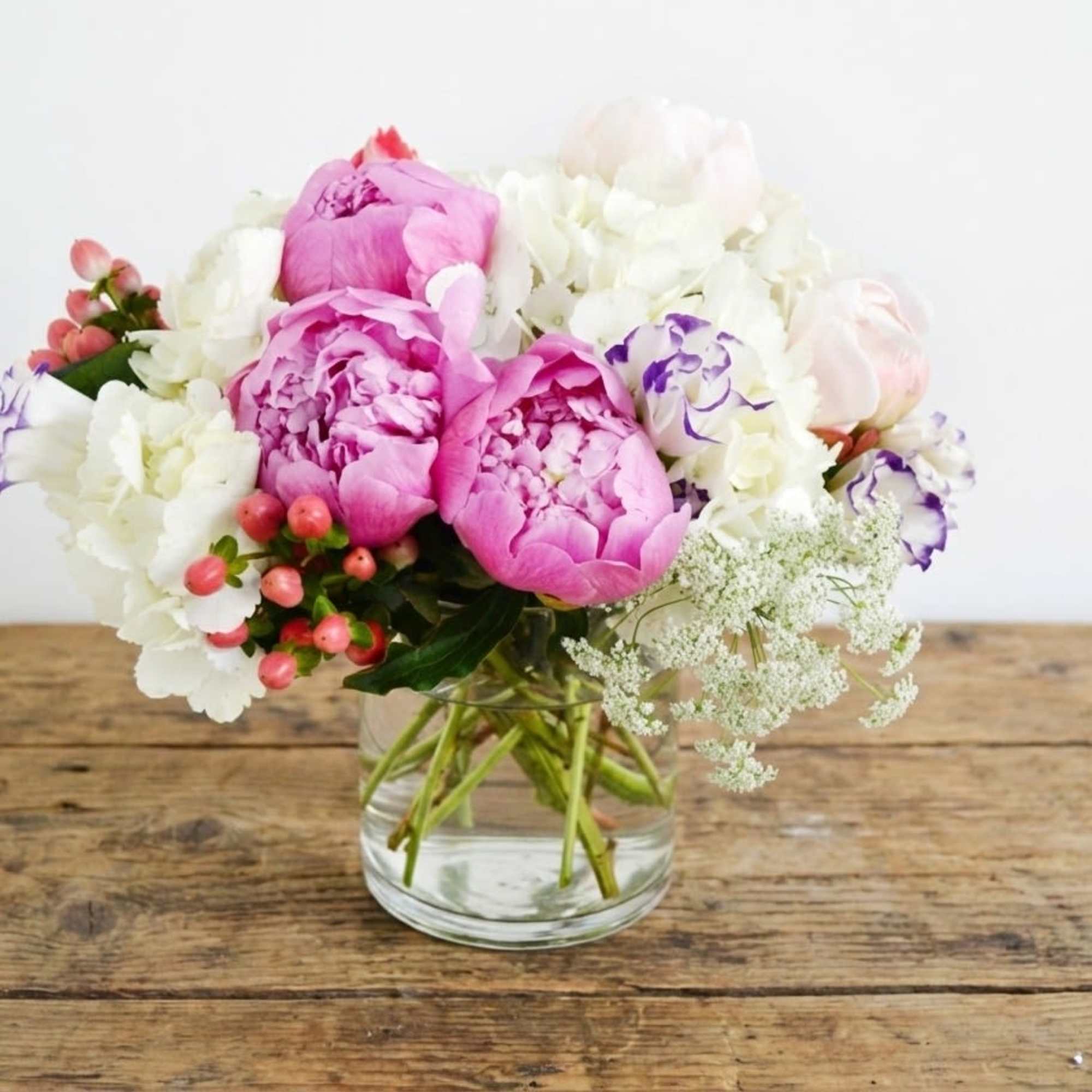 The standard size arrangement includes half dozen blush color peonies, white hydrangeas
