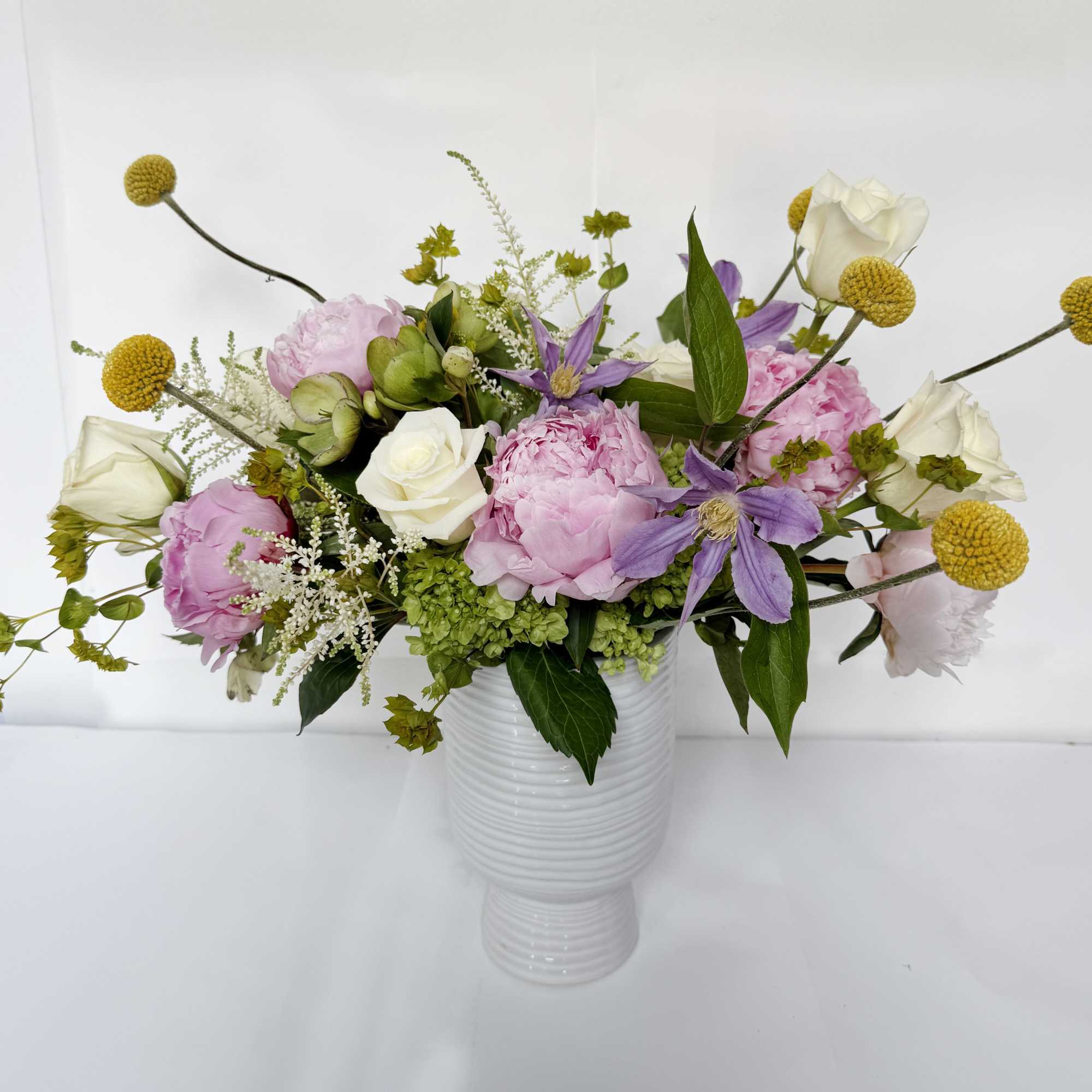 This floral arrangement showcases a beautiful blend of white and pink hues