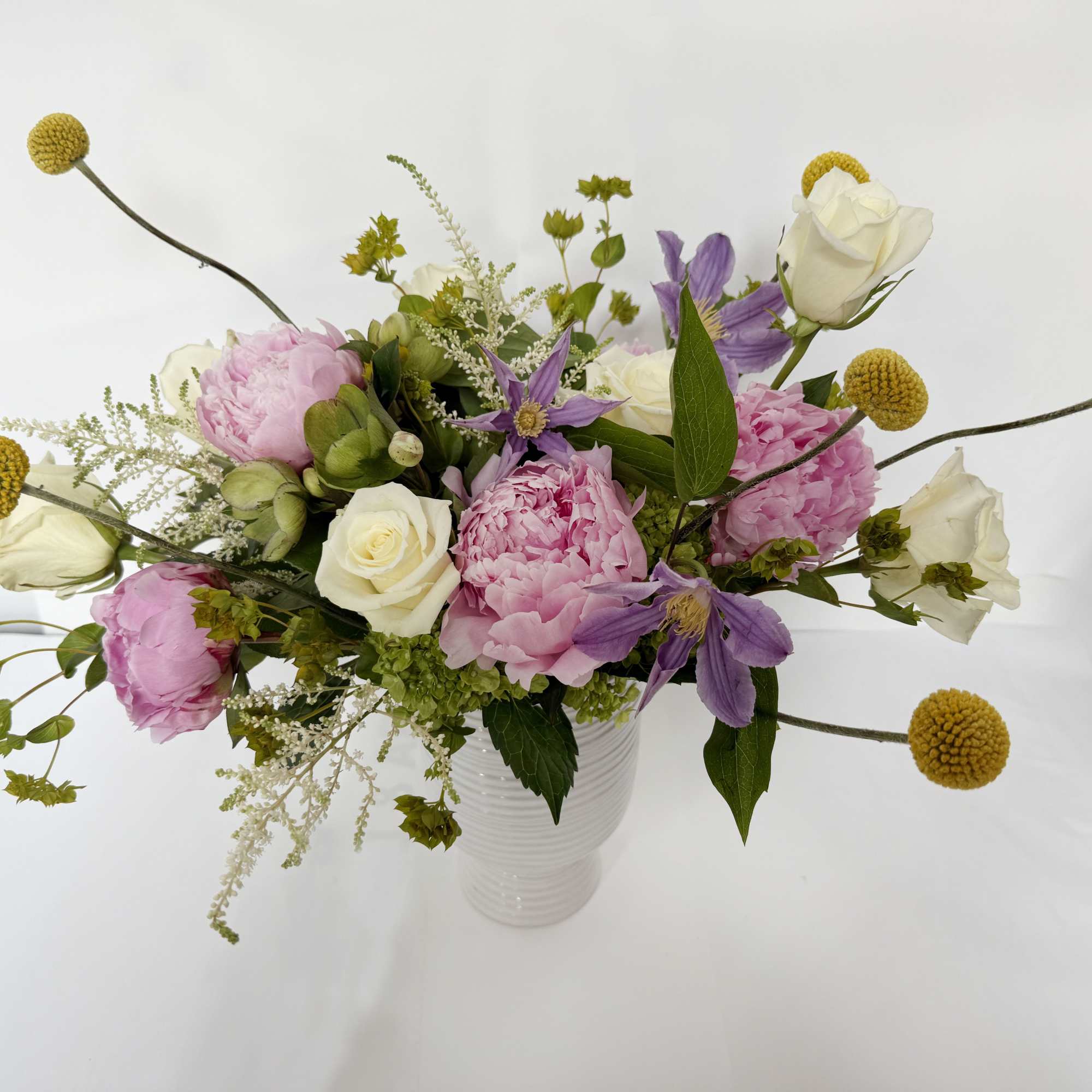 This floral arrangement showcases a beautiful blend of white and pink hues