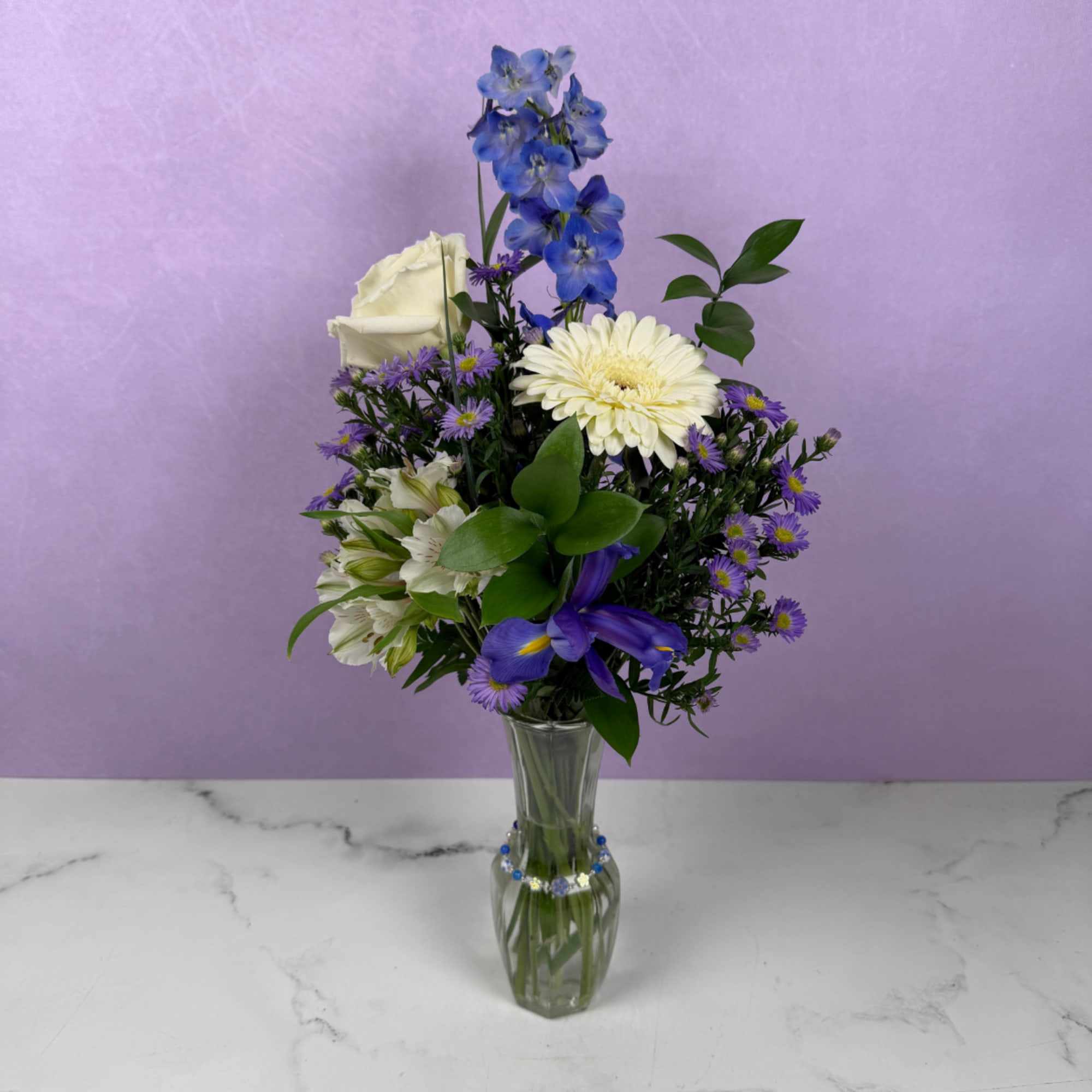 Unforgettable Love is an upright, airy flower arrangement of blue and ivory