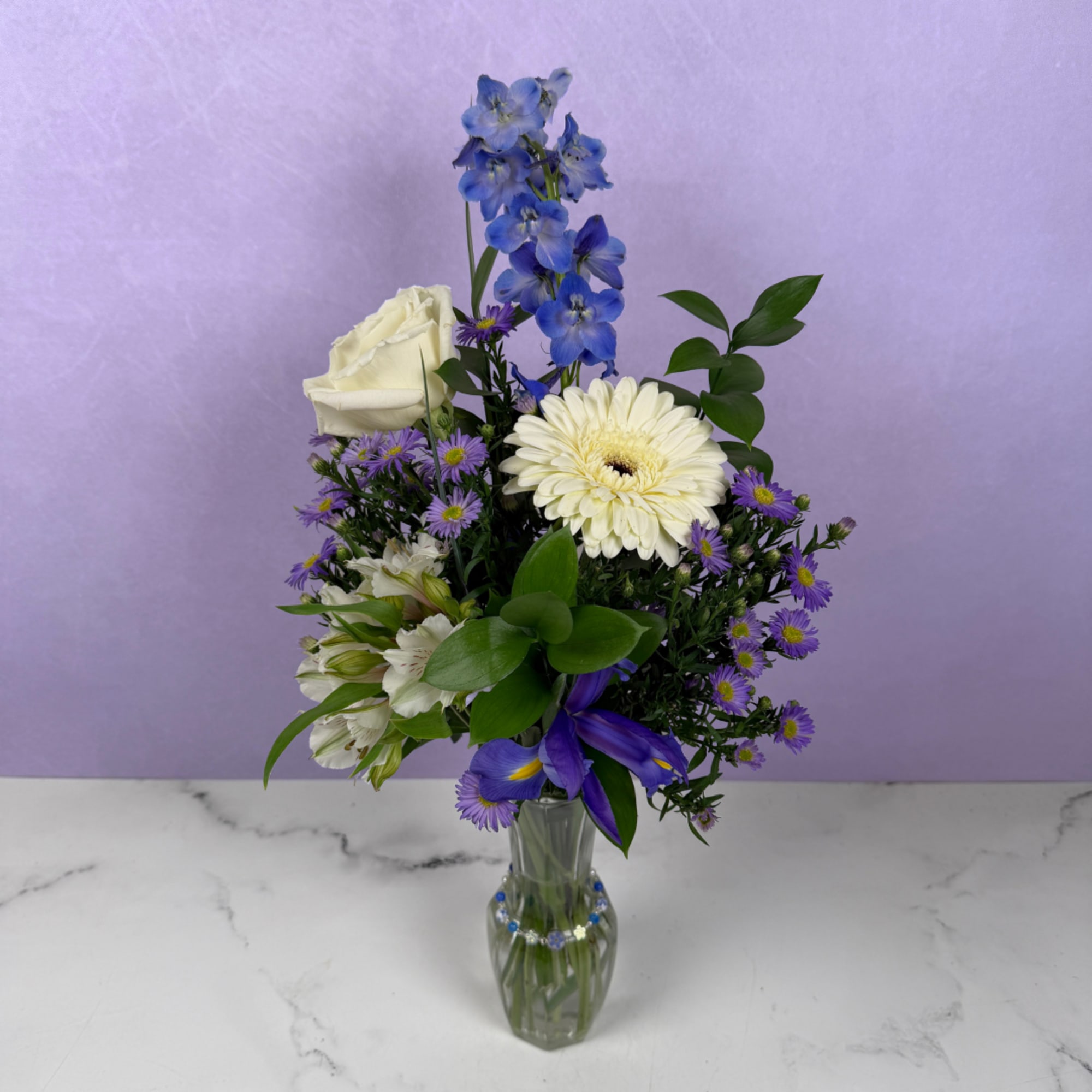 Unforgettable Love is an upright, airy flower arrangement of blue and ivory