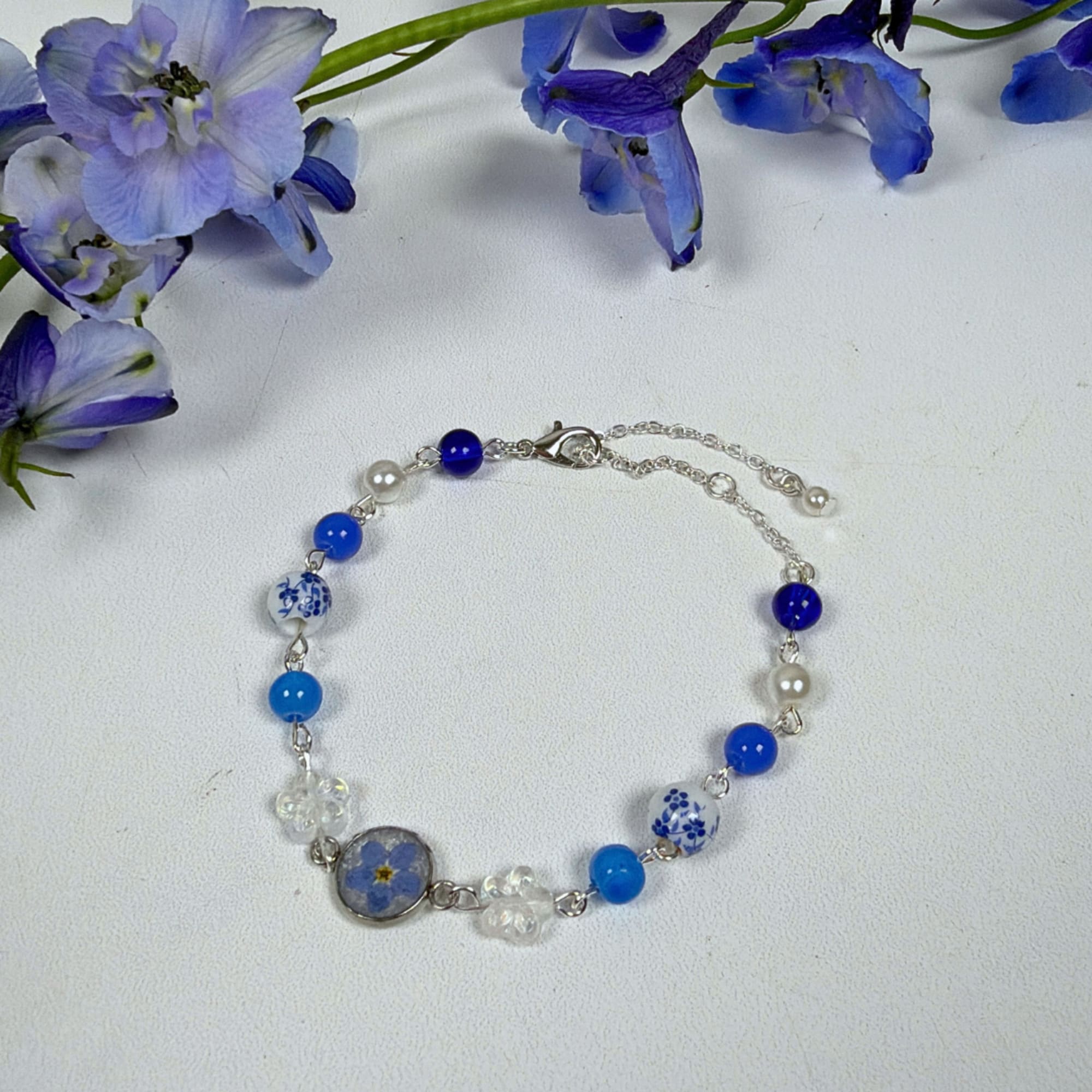 Unforgettable Love is an upright, airy flower arrangement of blue and ivory