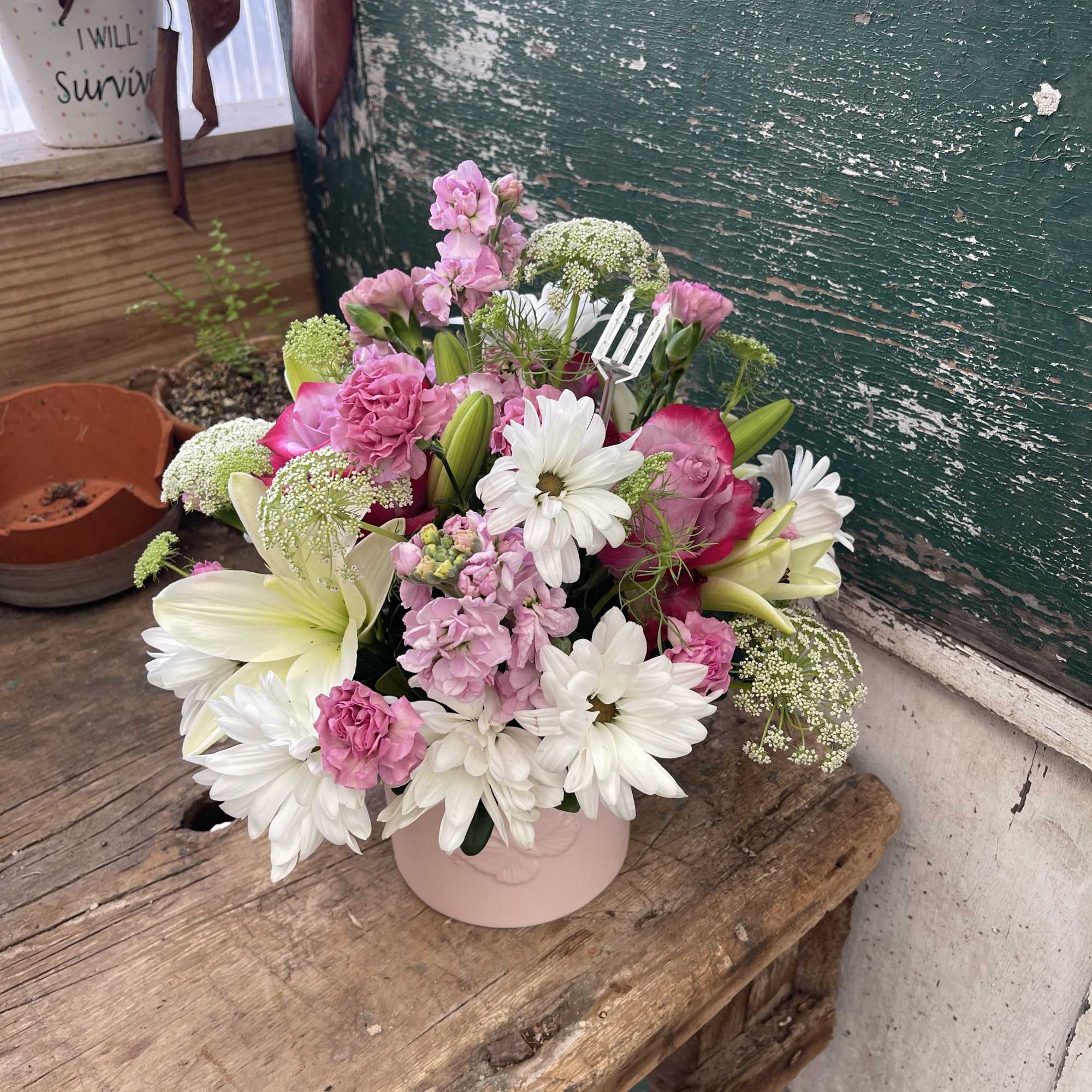 Pink and white mixed bouquet in a pale pink vase