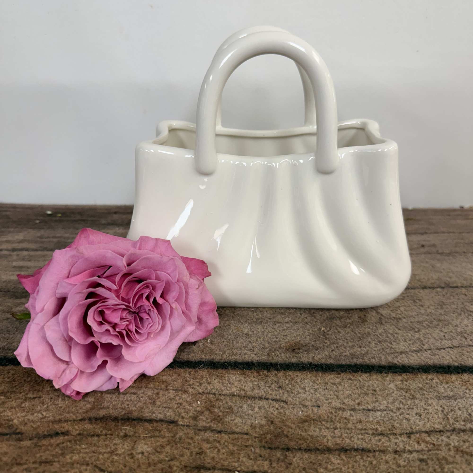 Cute ceramic purse holds Spring's beautiful tulips. Approx. 10"h x 12" w.